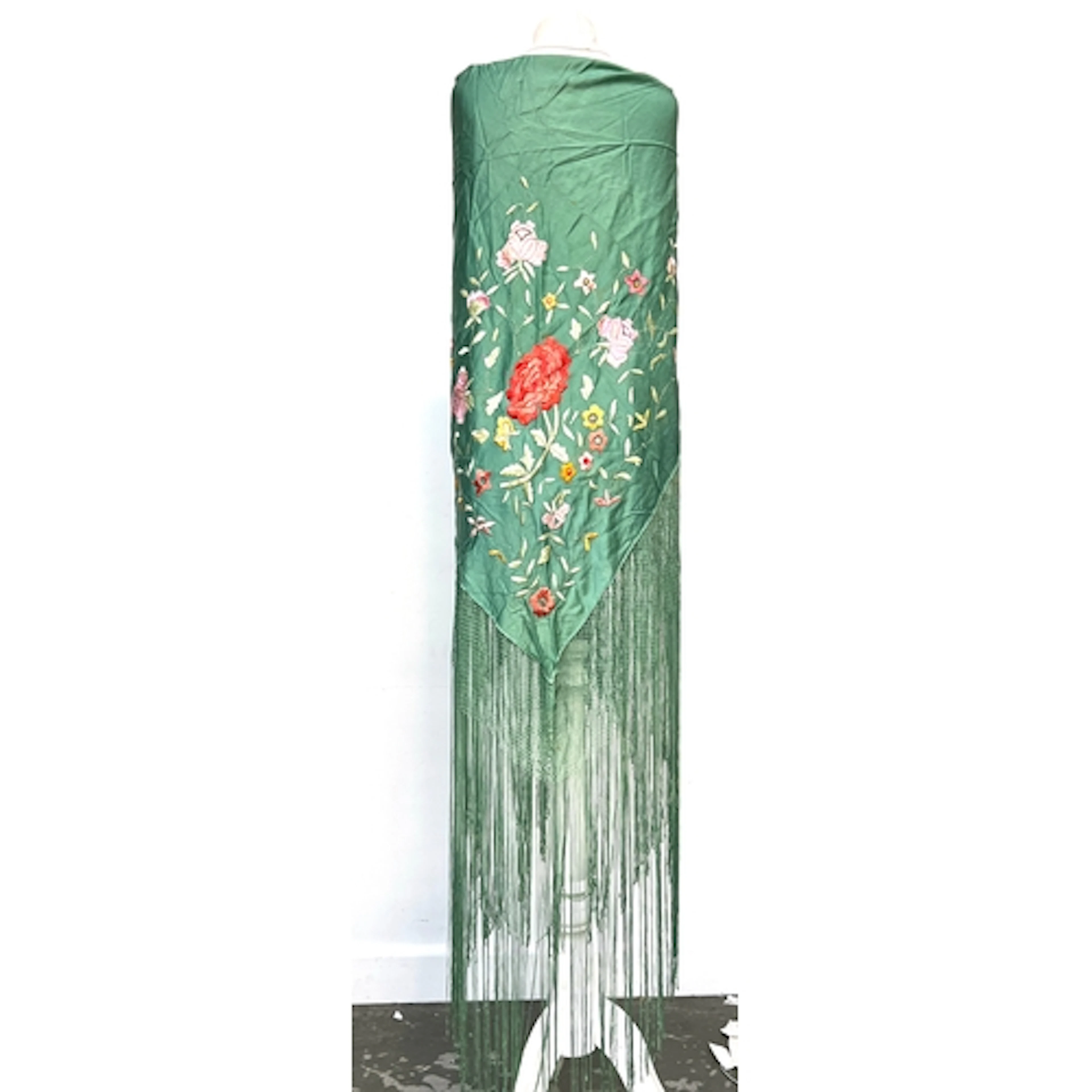 An early 20th century green silk piano shawl with floral emb...