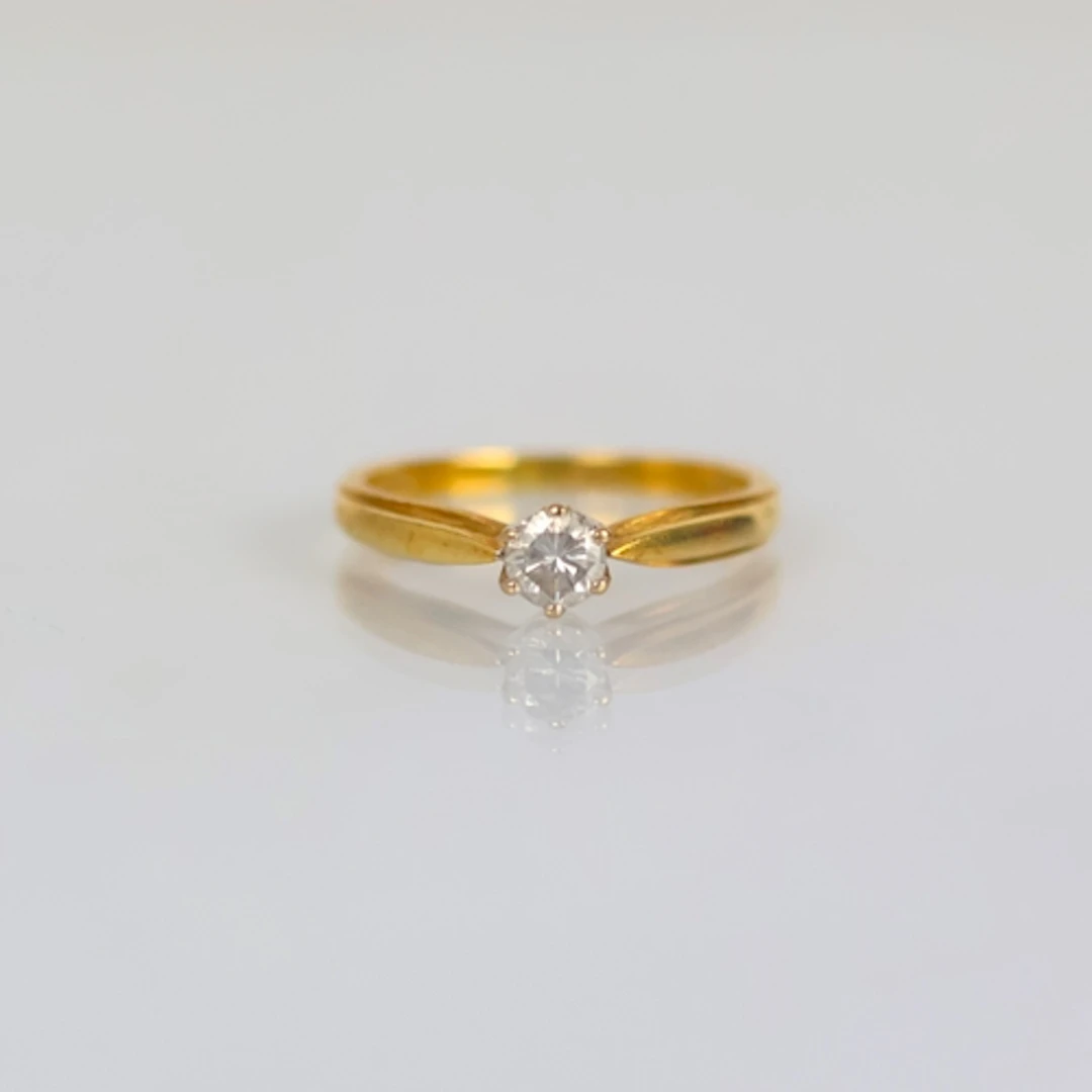 A late 20th century 18ct yellow gold diamond solitaire, the ...