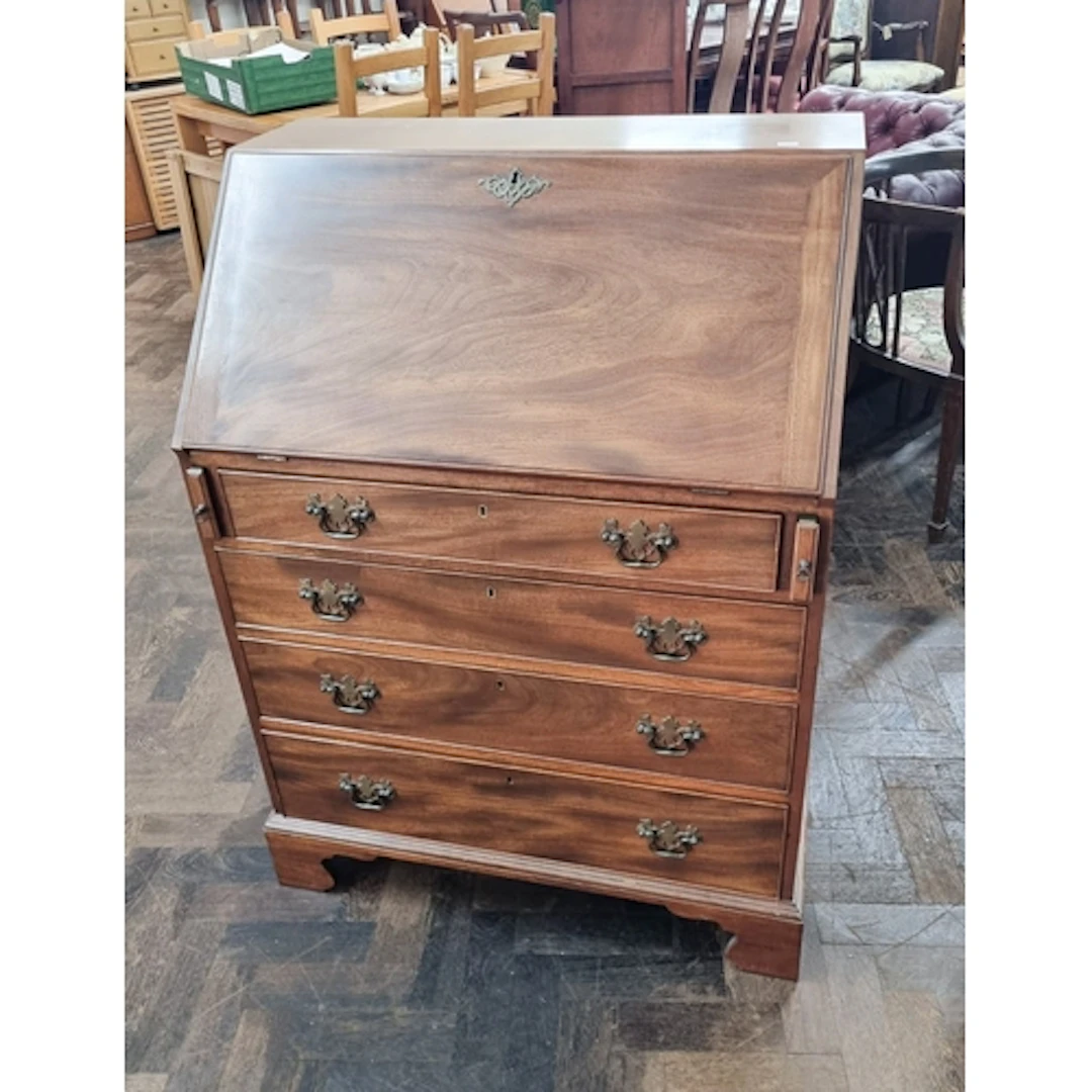 A Georgian style mahogany bureau with four long drawers unde...