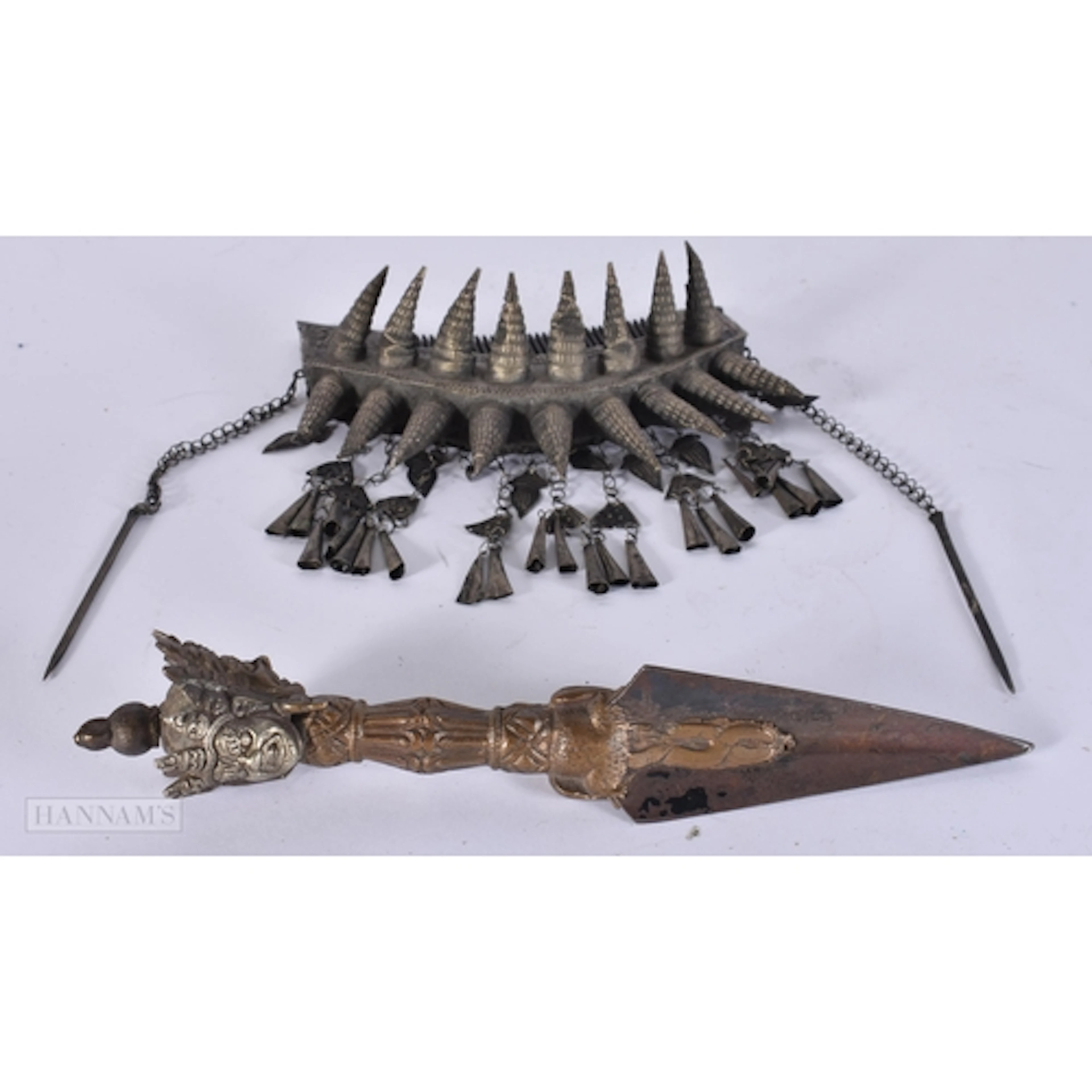 A 19TH CENTURY TIBETAN BRONZE PHURBA and a white metal hair ...