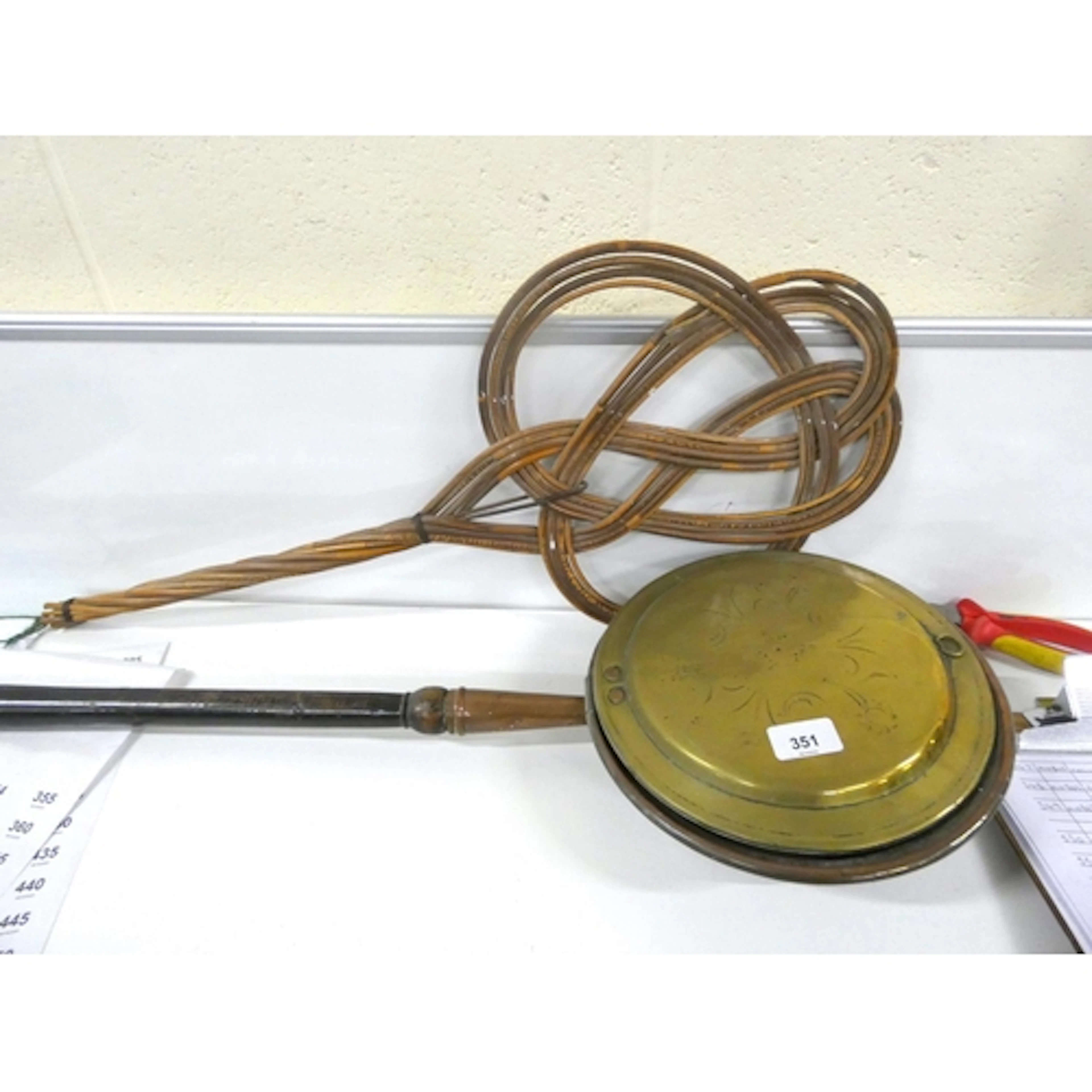 Vintage carpet beater and brass bed warmer.