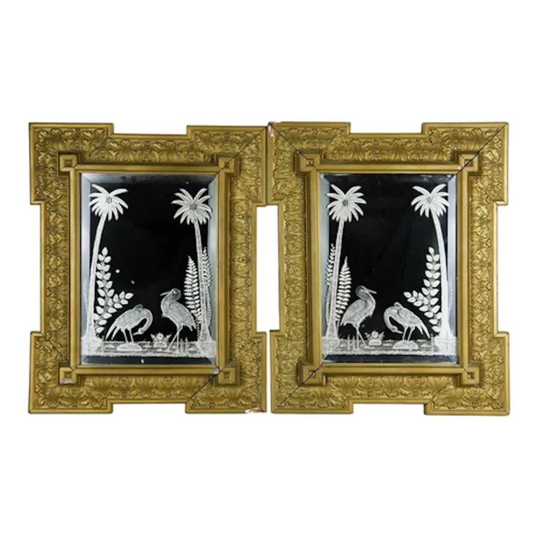 A pair of Hollywood Regency style gilt framed wall mirrors. ...