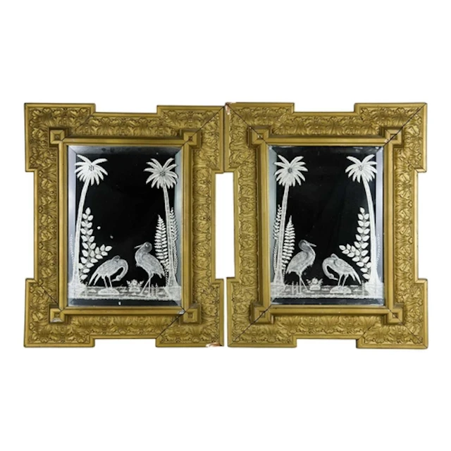 A pair of Hollywood Regency style gilt framed wall mirrors. ...
