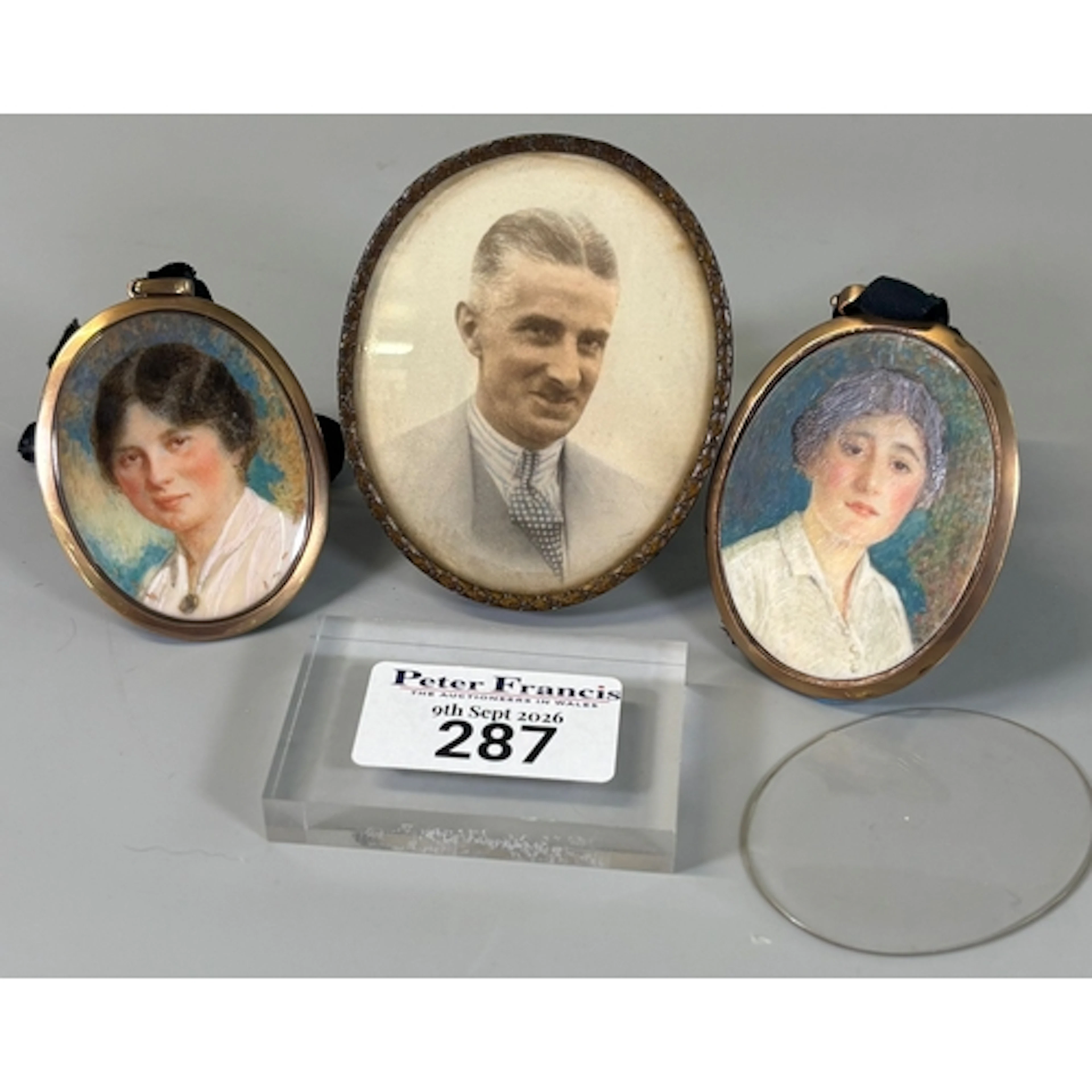 Pair of early 20th century oval portrait miniatures of young...