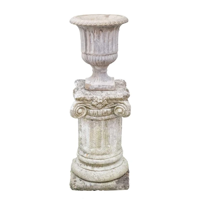 A cast stone fluted urn. Raised on associated ionic column p...