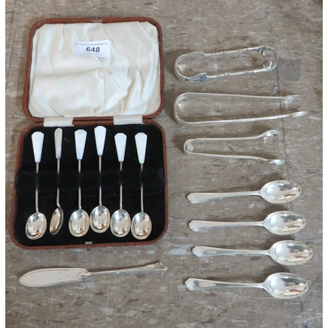 Various silver coffee spoons and tongs, together with a silv...