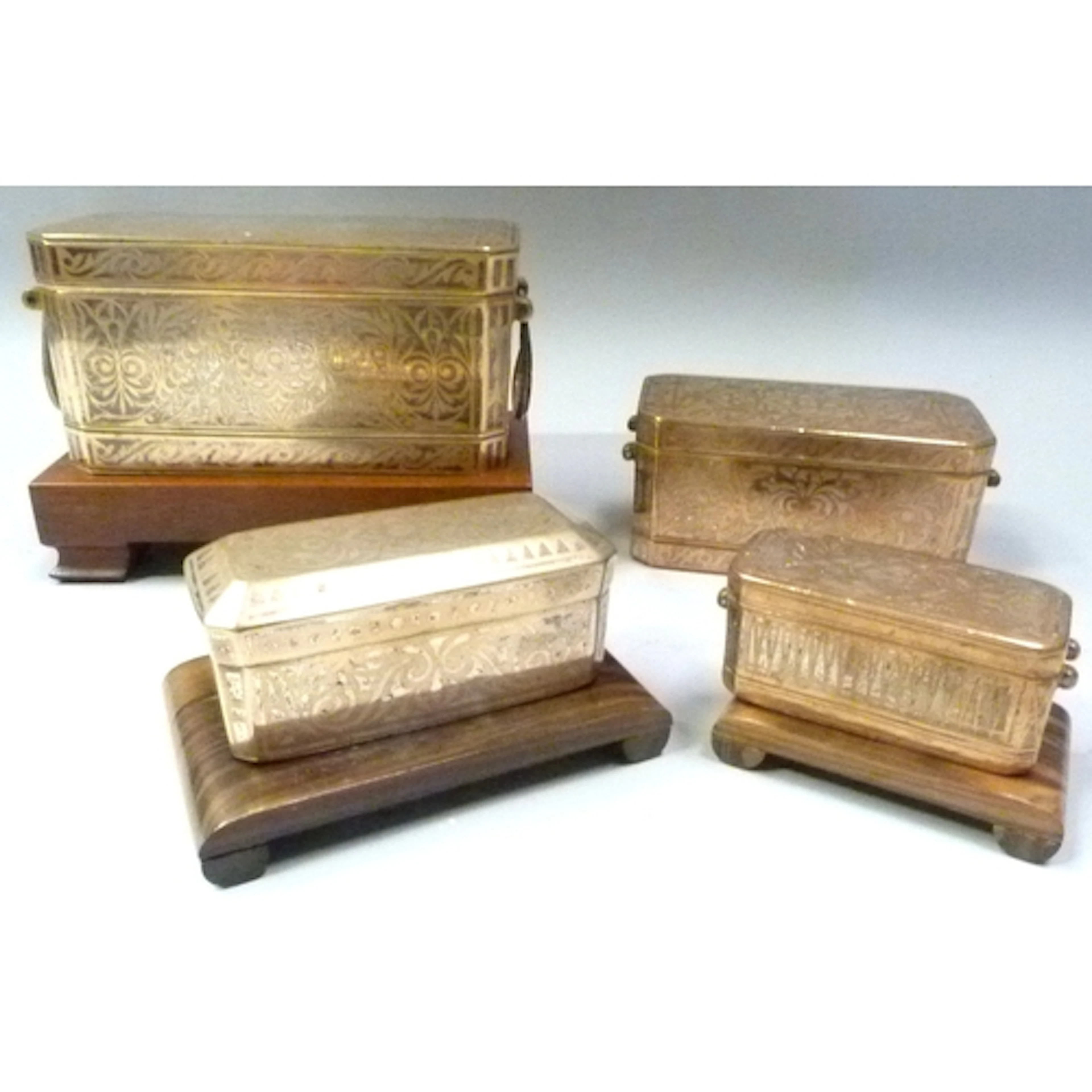 Group of four inlaid on bronzed metal Mindanao betel nut box...