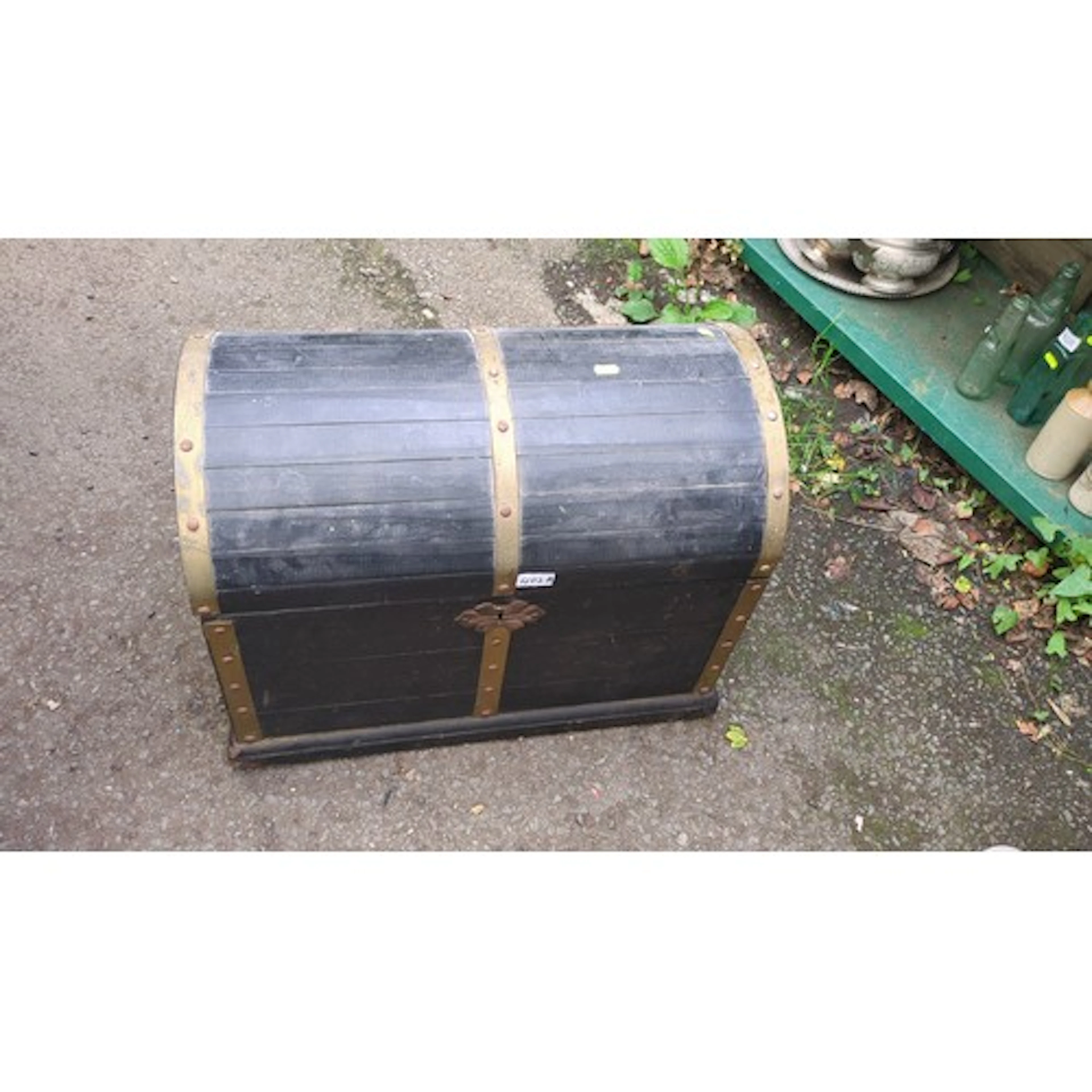 Domed-top storage trunk in ebonised wood, the lid strapped w...