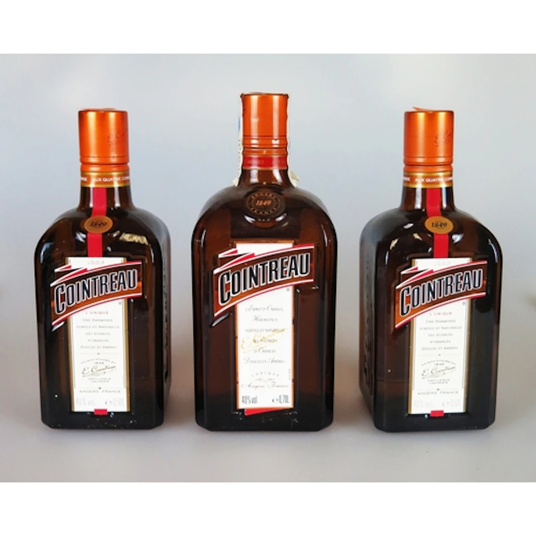 Three bottles of Cointreau, one 70cl and two 50cl. ALCOHOL ...