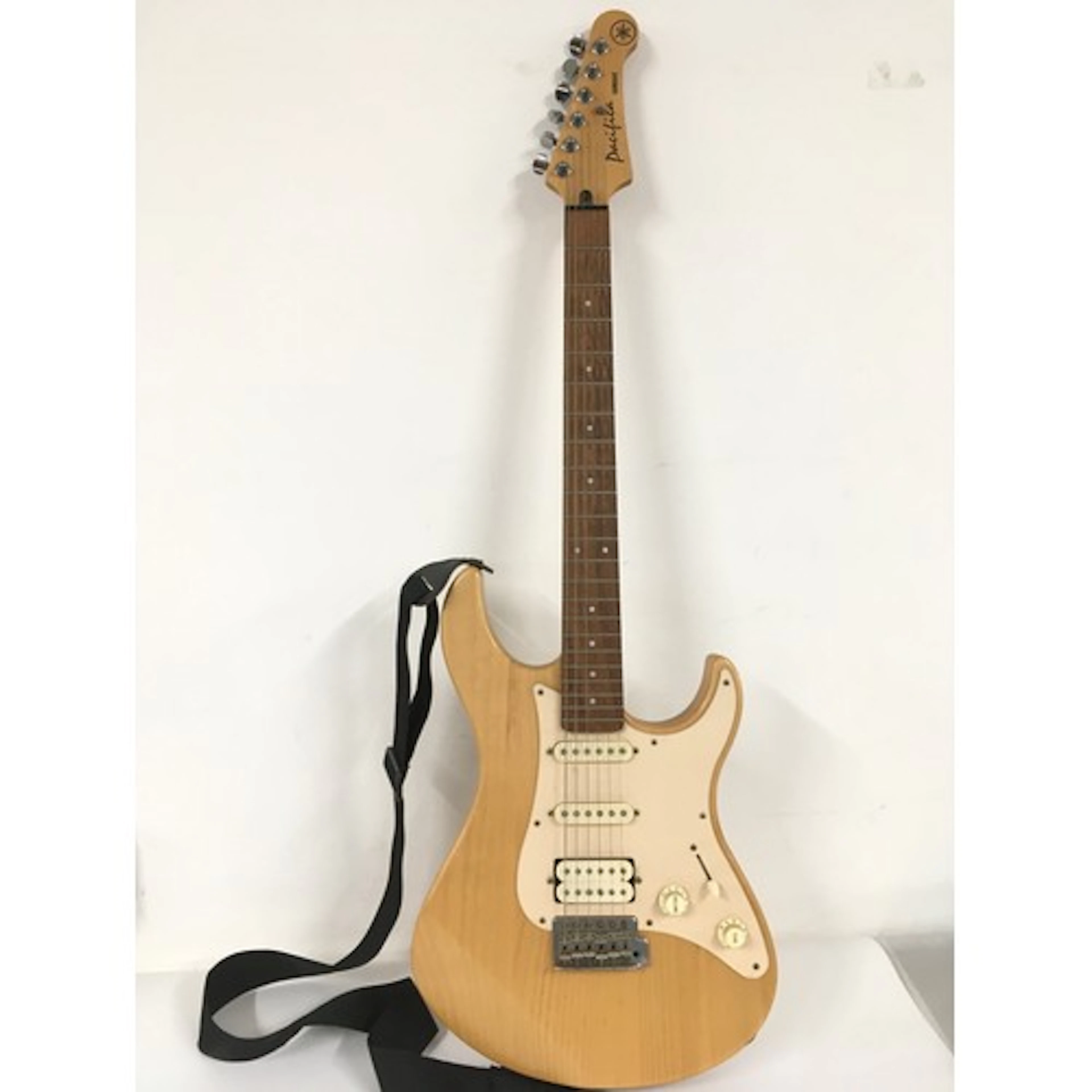 A Yamaha Pacifica electric guitar, no case.