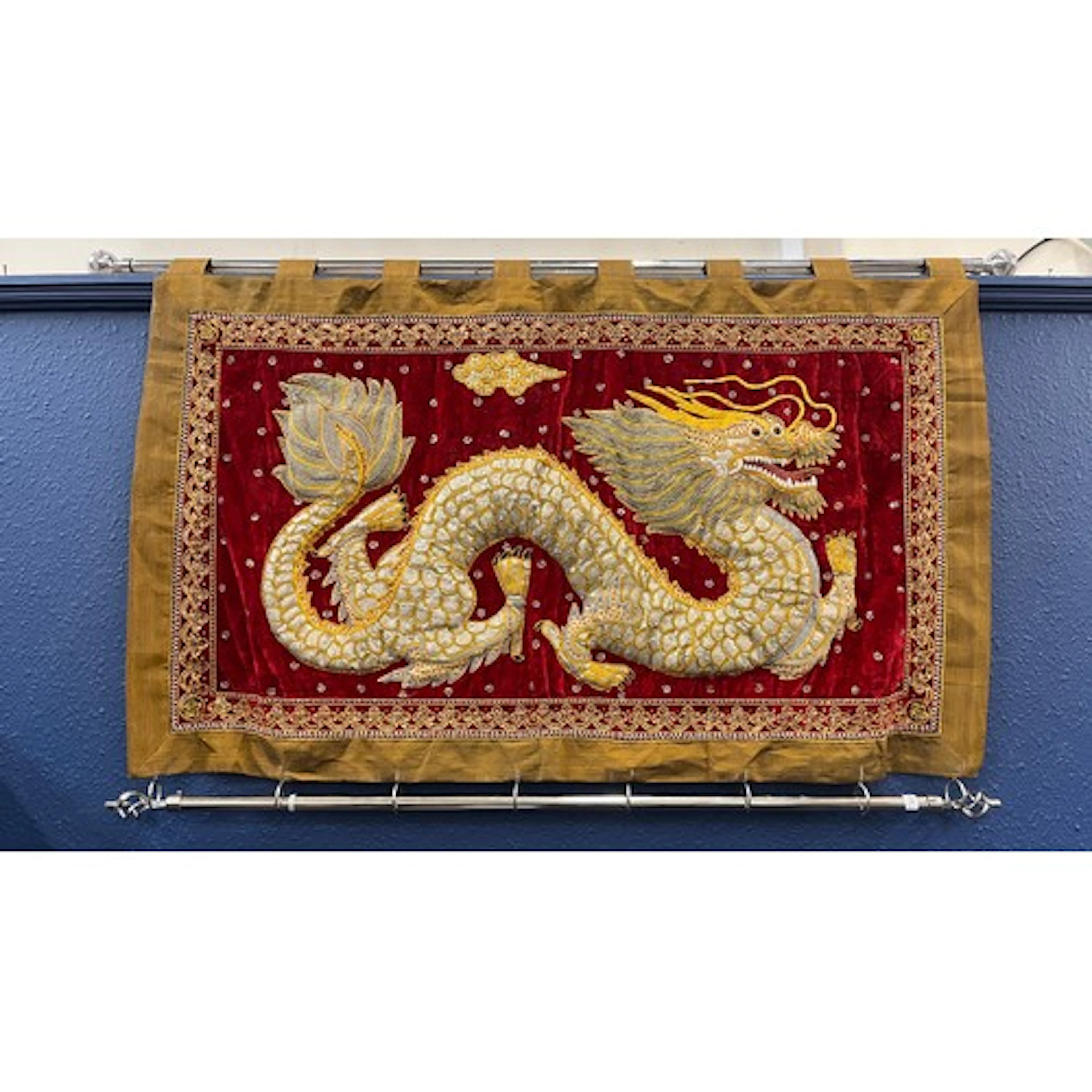 Middle Eastern wall hanging of a dragon on a red background