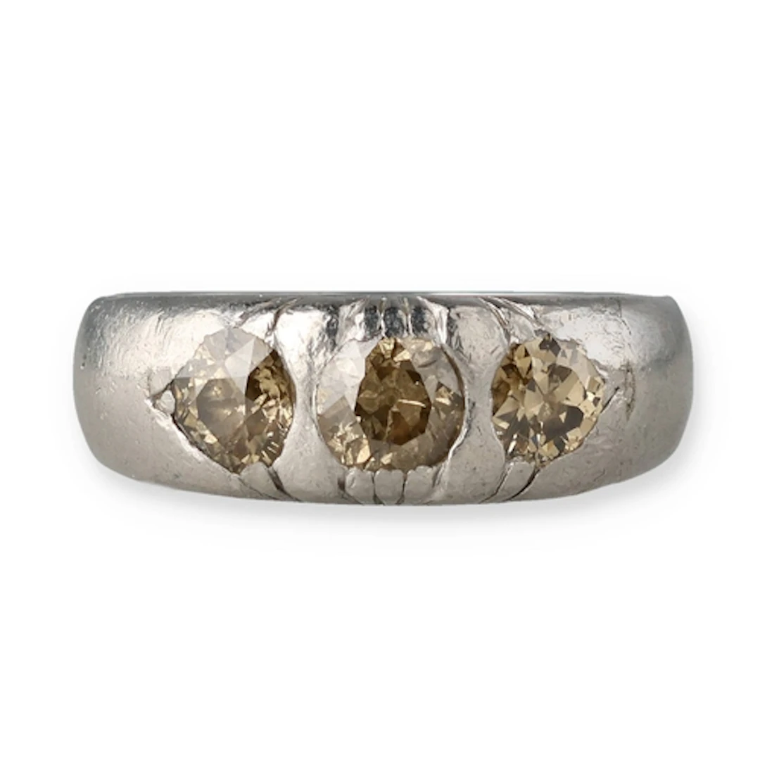 A PLATINUM TRI-STONE DIAMOND RING With central diamond surro...