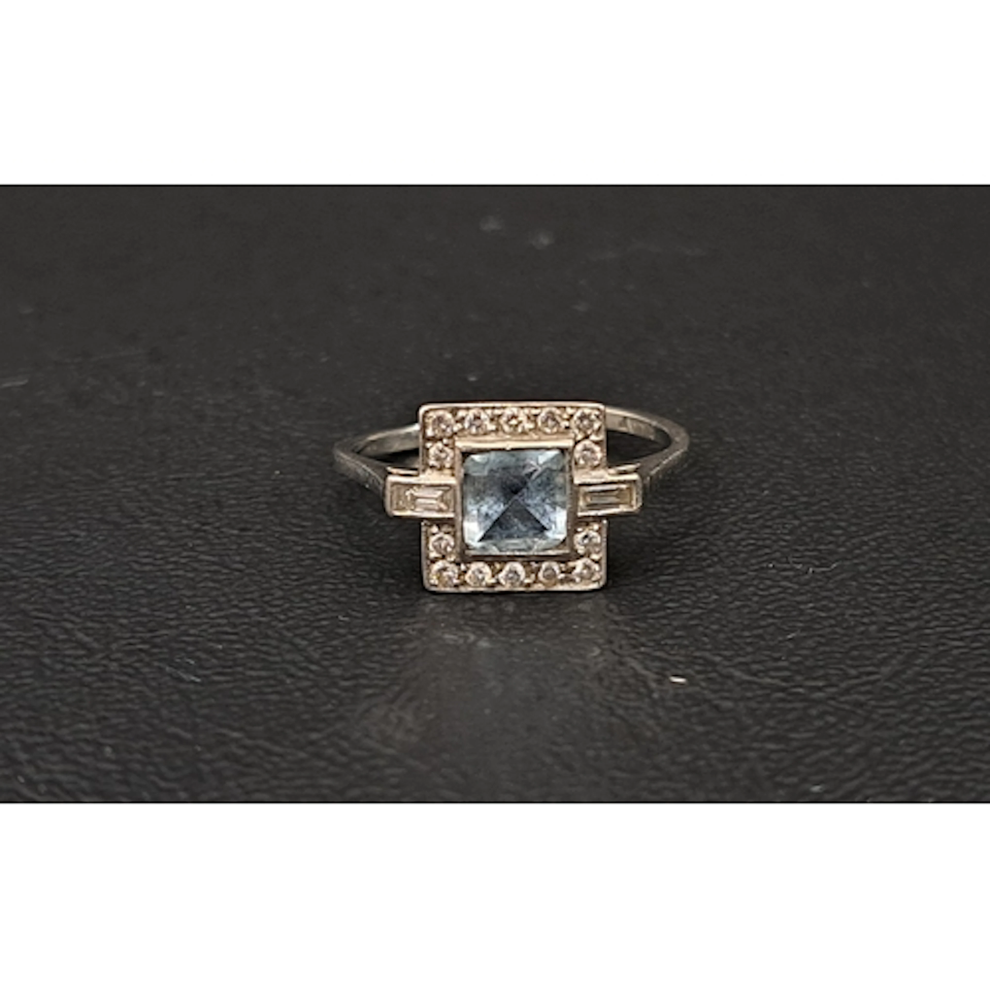 AQUAMARINE AND DIAMOND CLUSTER RING the central square cut a...