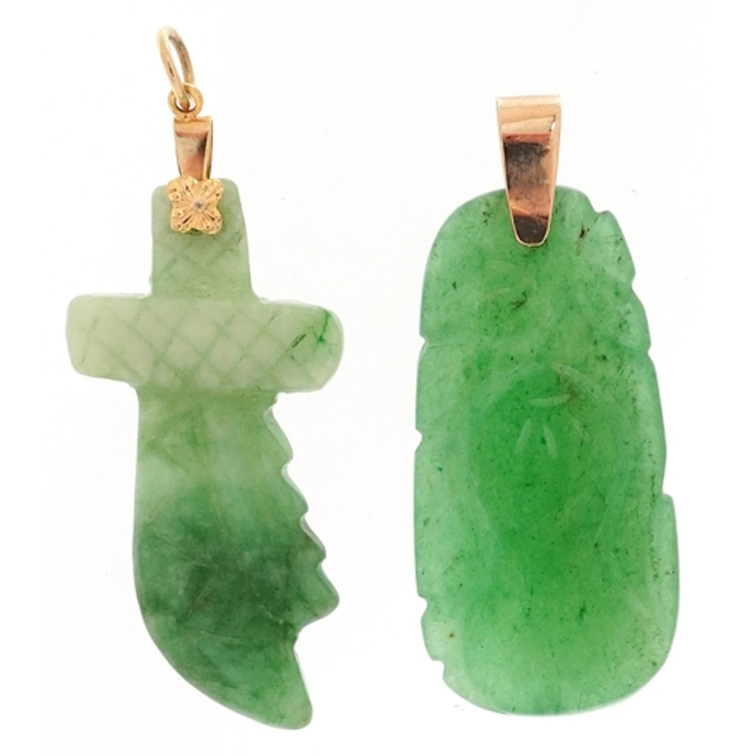 Two Chinese green stone pendants with yellow metal mounts, t...