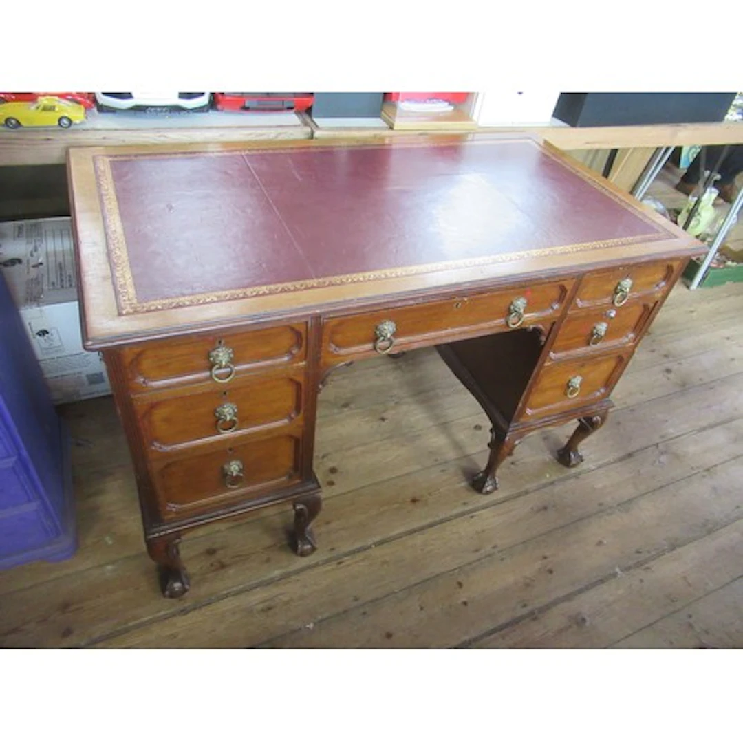 A 19th century writing desk with leather inset raised on cla...