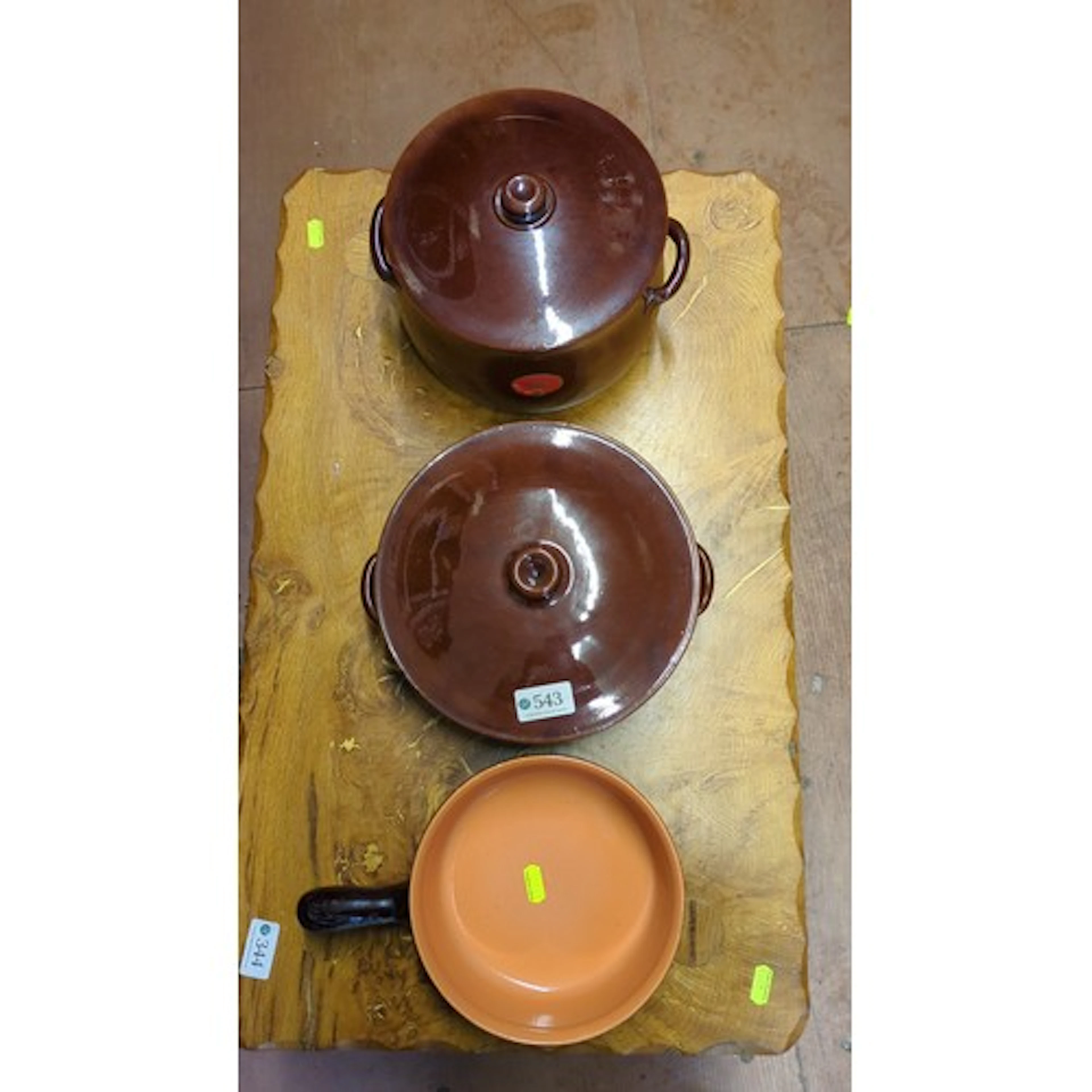 A group of glazed earthenware casserole dishes and covers, i...