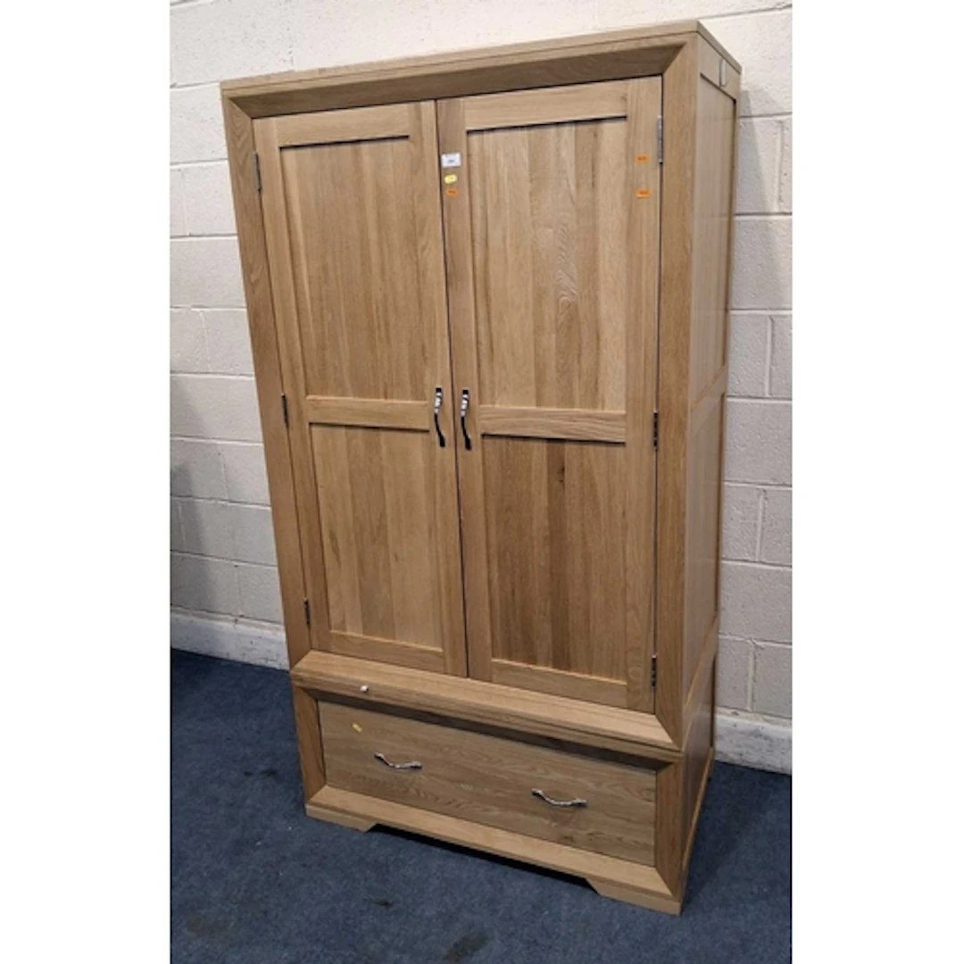 A MODERN LIGHT OAK DOUBLE DOOR WARDROBE, with a single drawe...