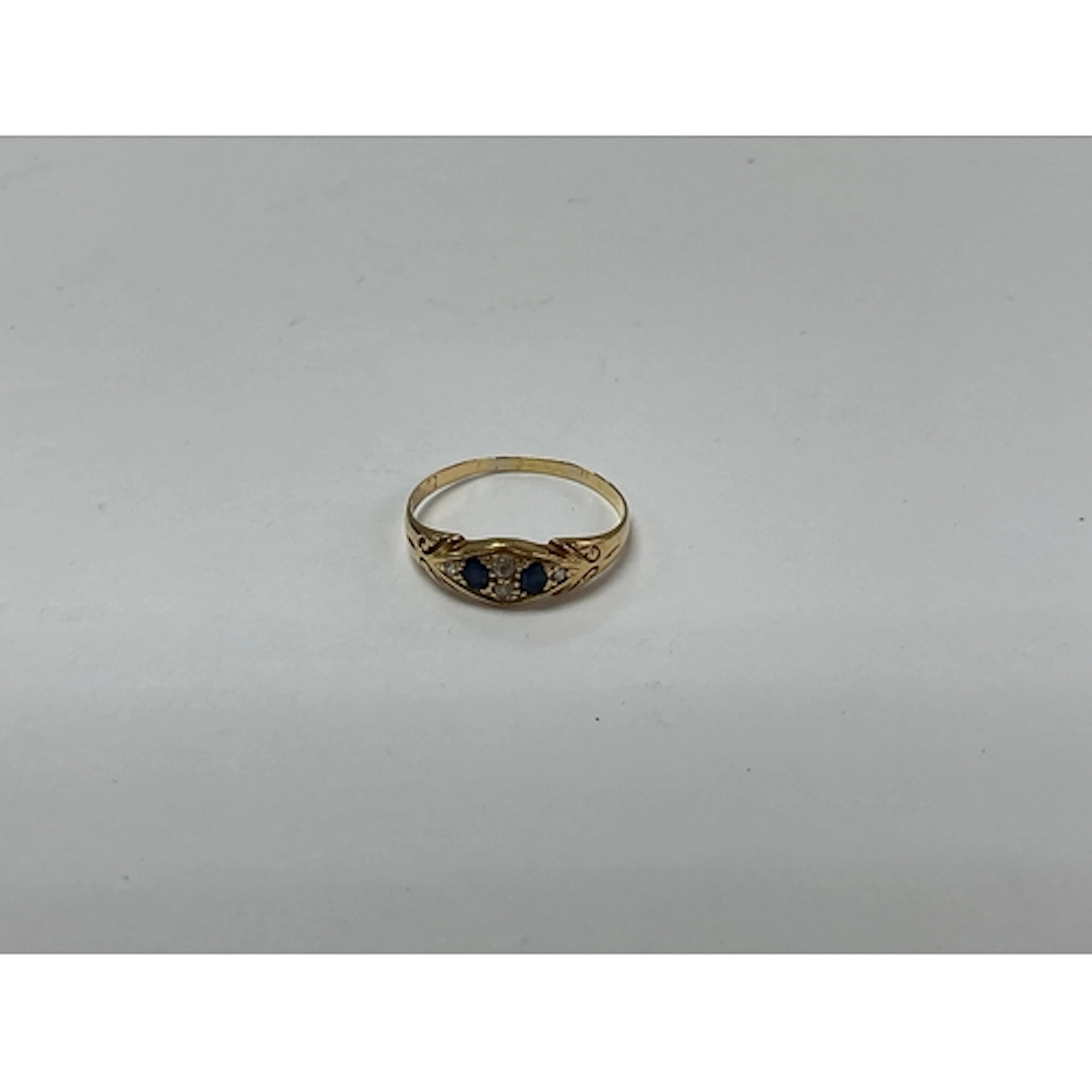 An 18ct gold ring set with two sapphires. Approx size S 2.27...