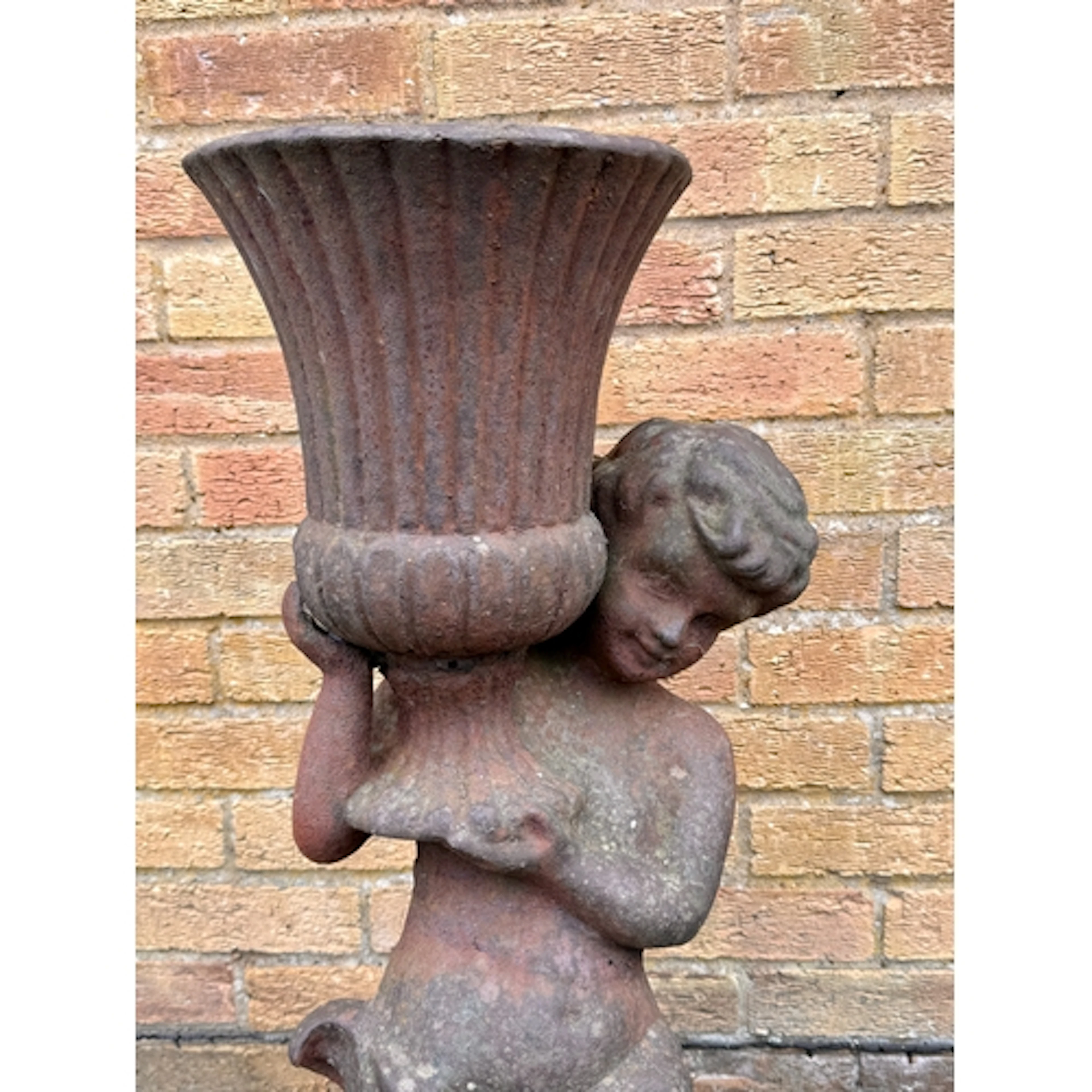 A cast iron garden figural urn - probably early 20th century...