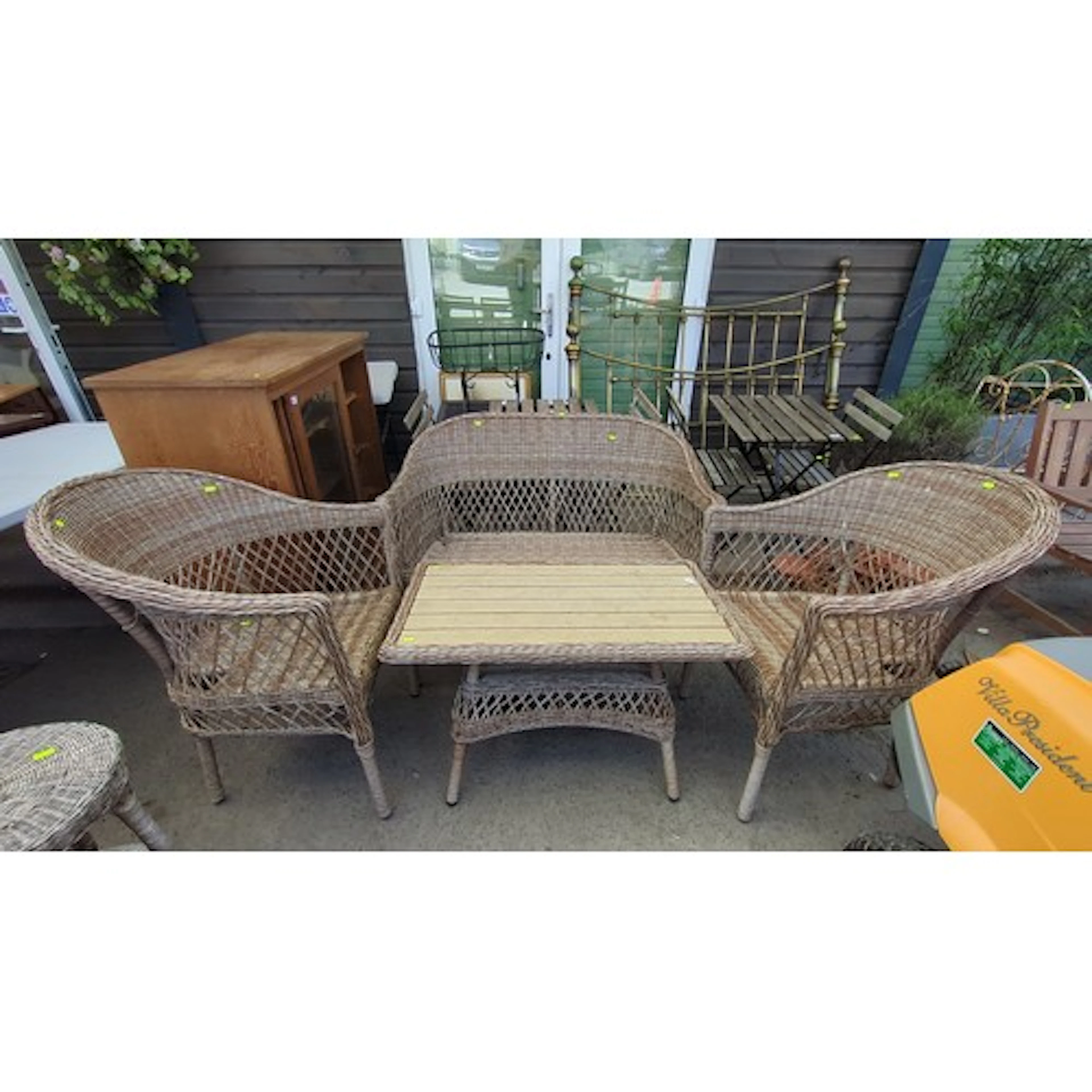 A suite of woven wicker conservatory furniture, including a ...