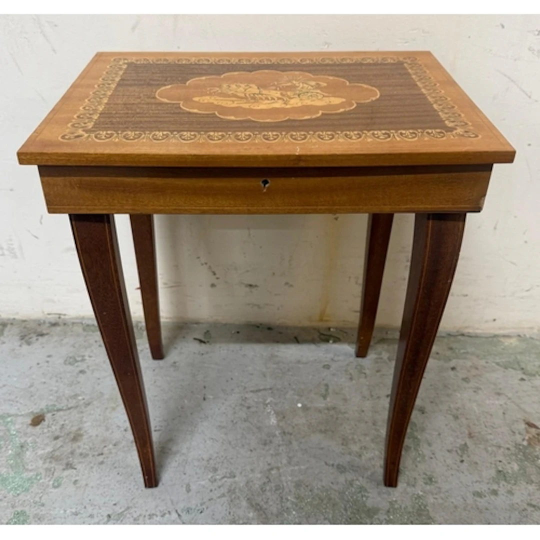An Italian marquetry inlaid music box on legs with hinged li...