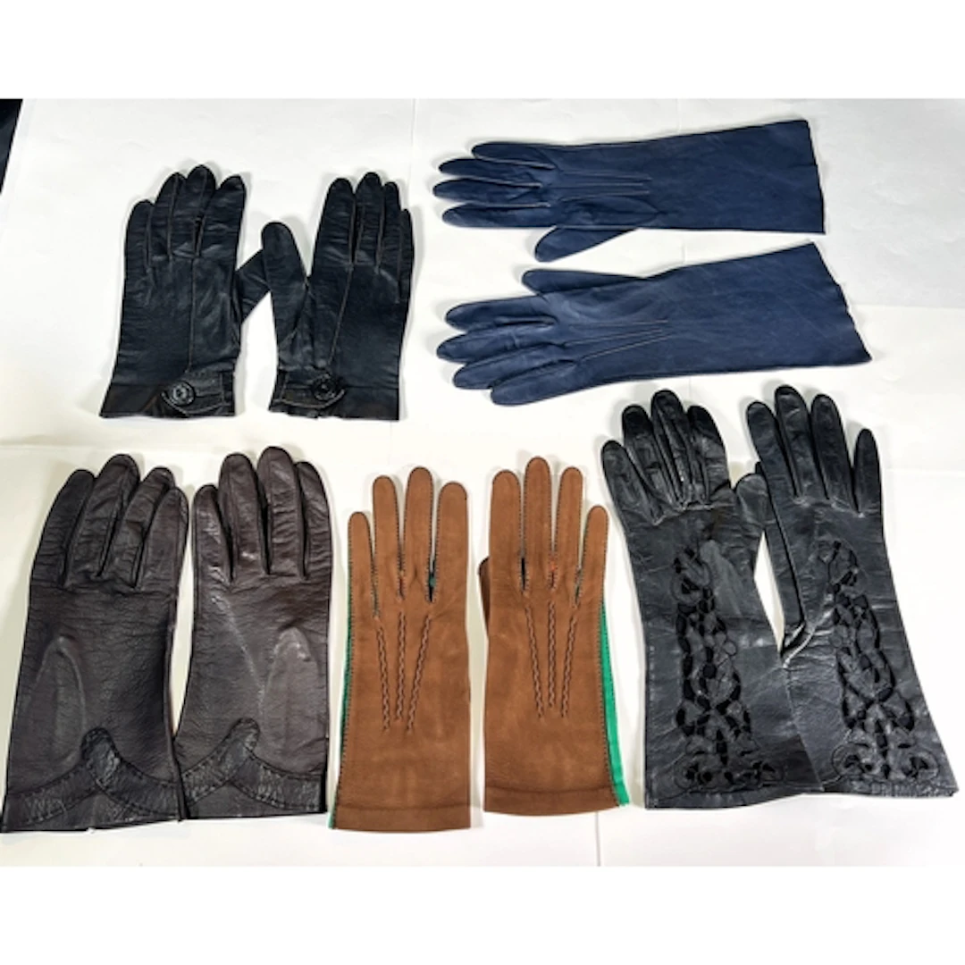 A pair of mid 20th century black leather gloves with openwor...