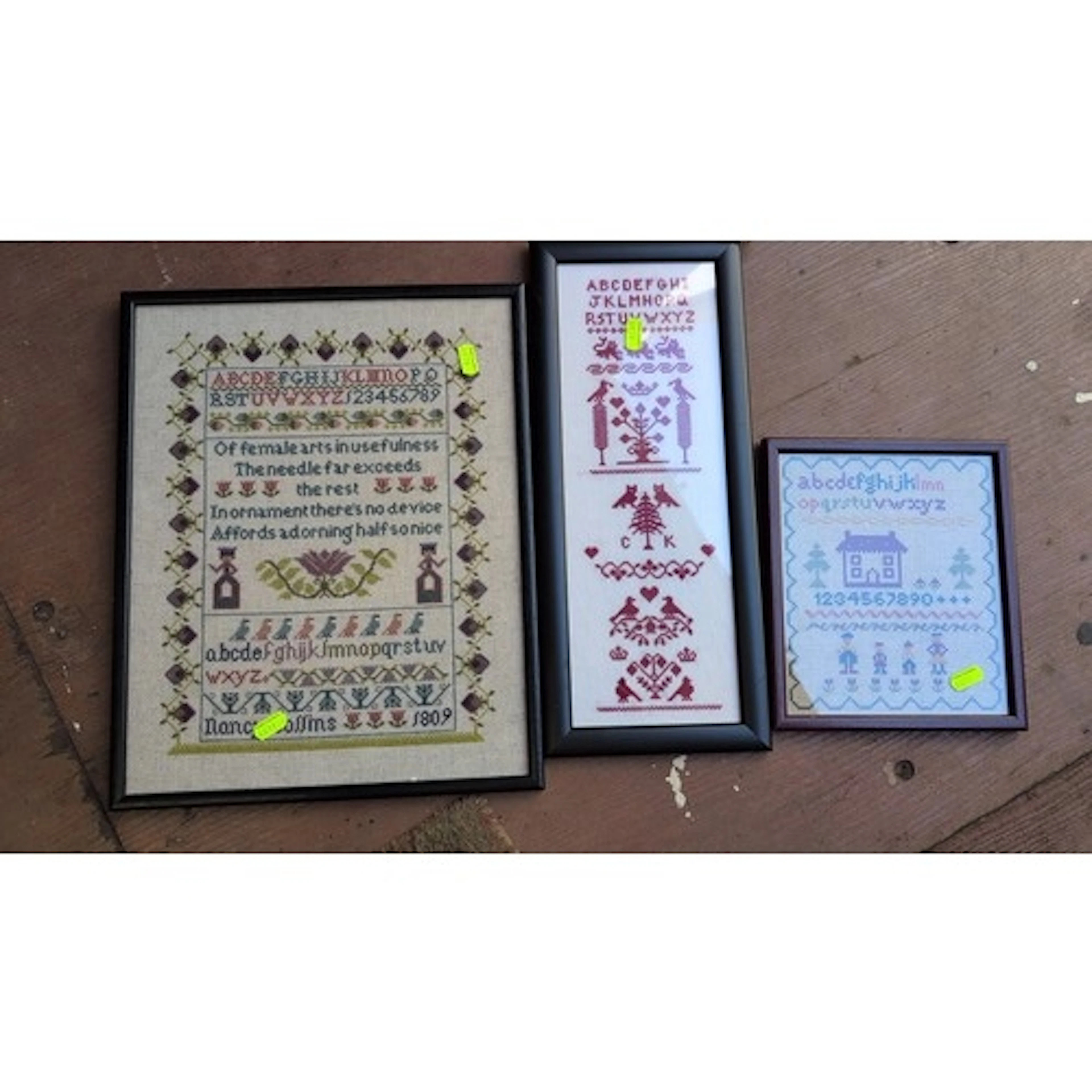 A group of framed needlepoint samplers on linen ground, comp...