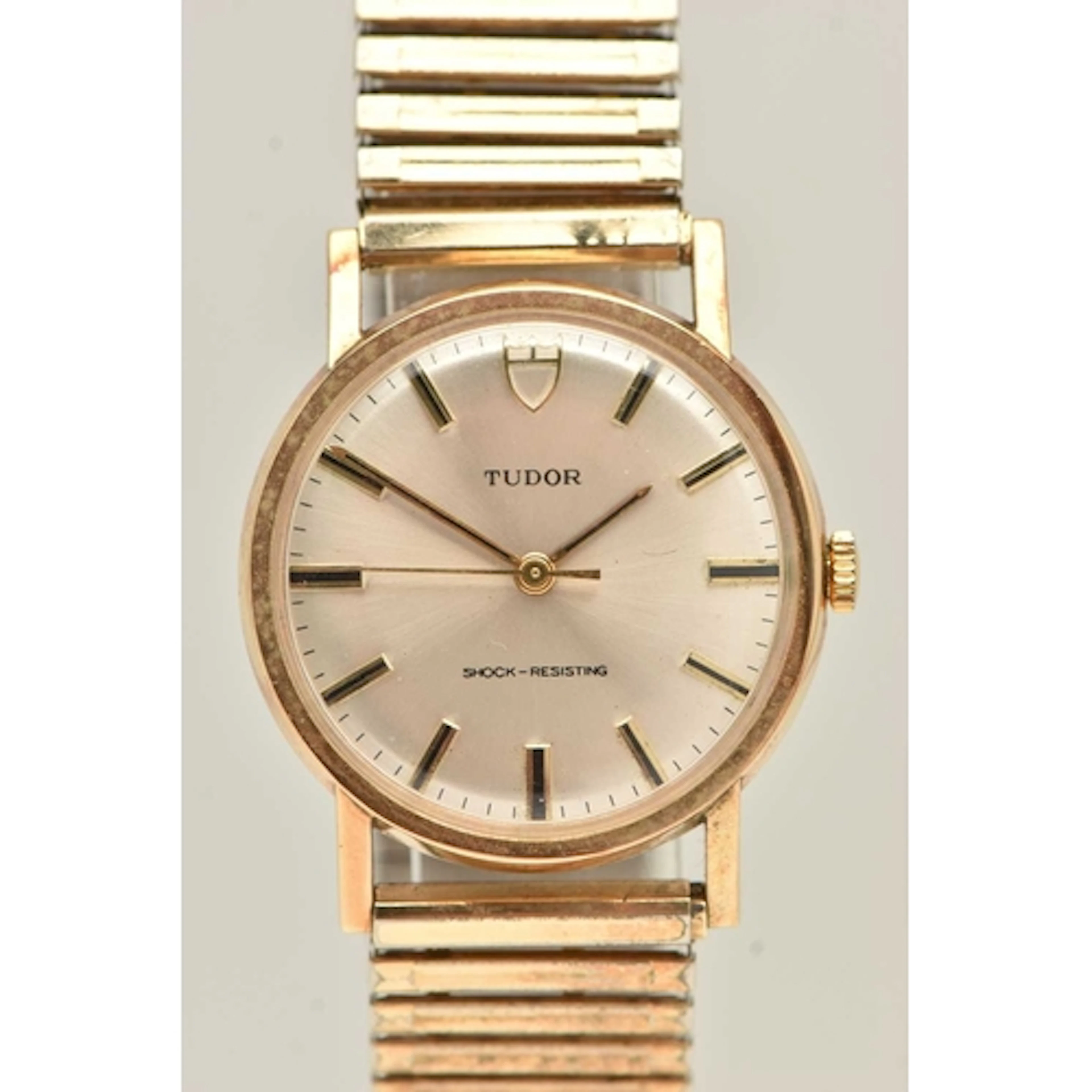 A VINTAGE TUDOR 9CT GOLD WRISTWATCH. The silver tone dial wi...