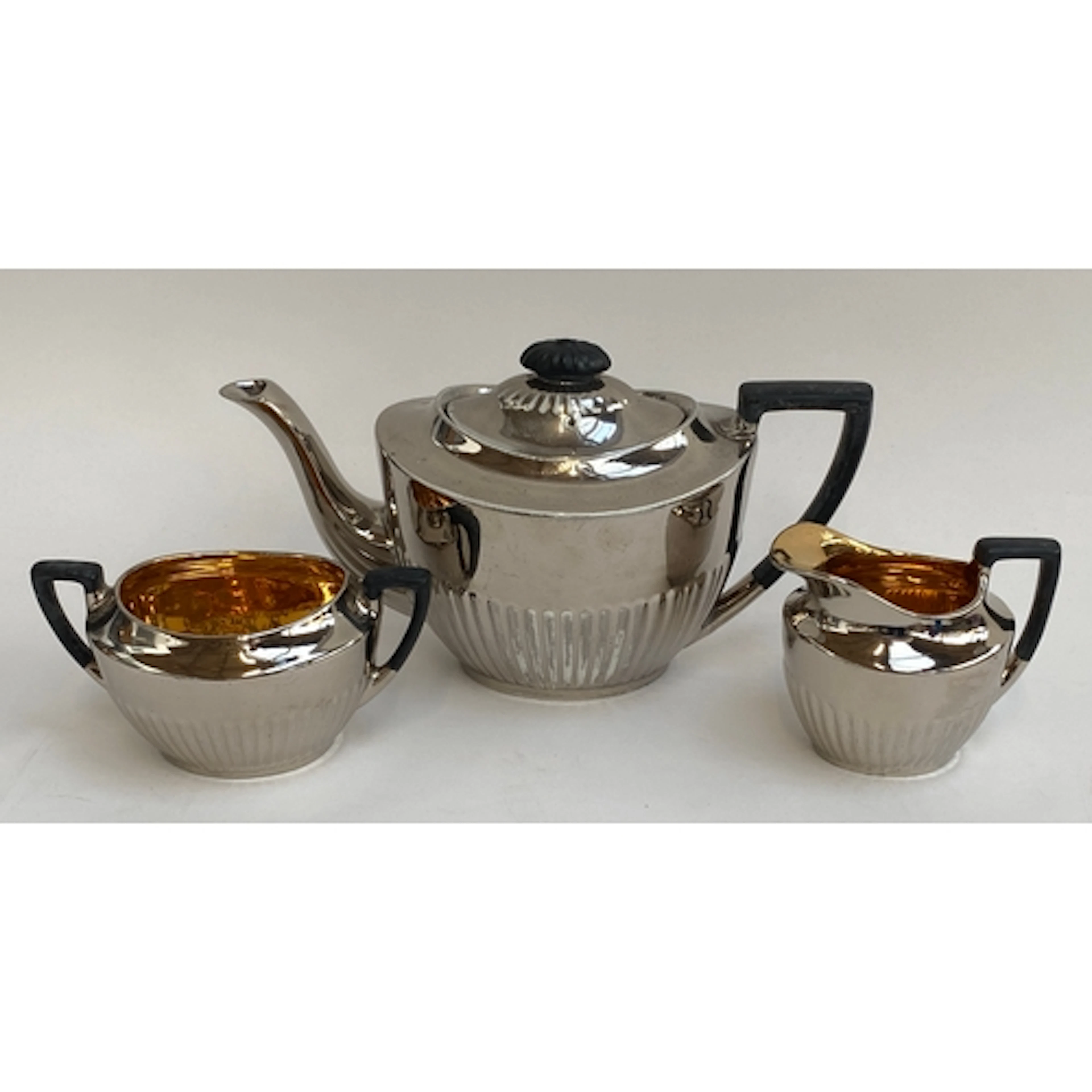 A 1930s silver lustre ceramic teapot, milk jug and sugar bow...