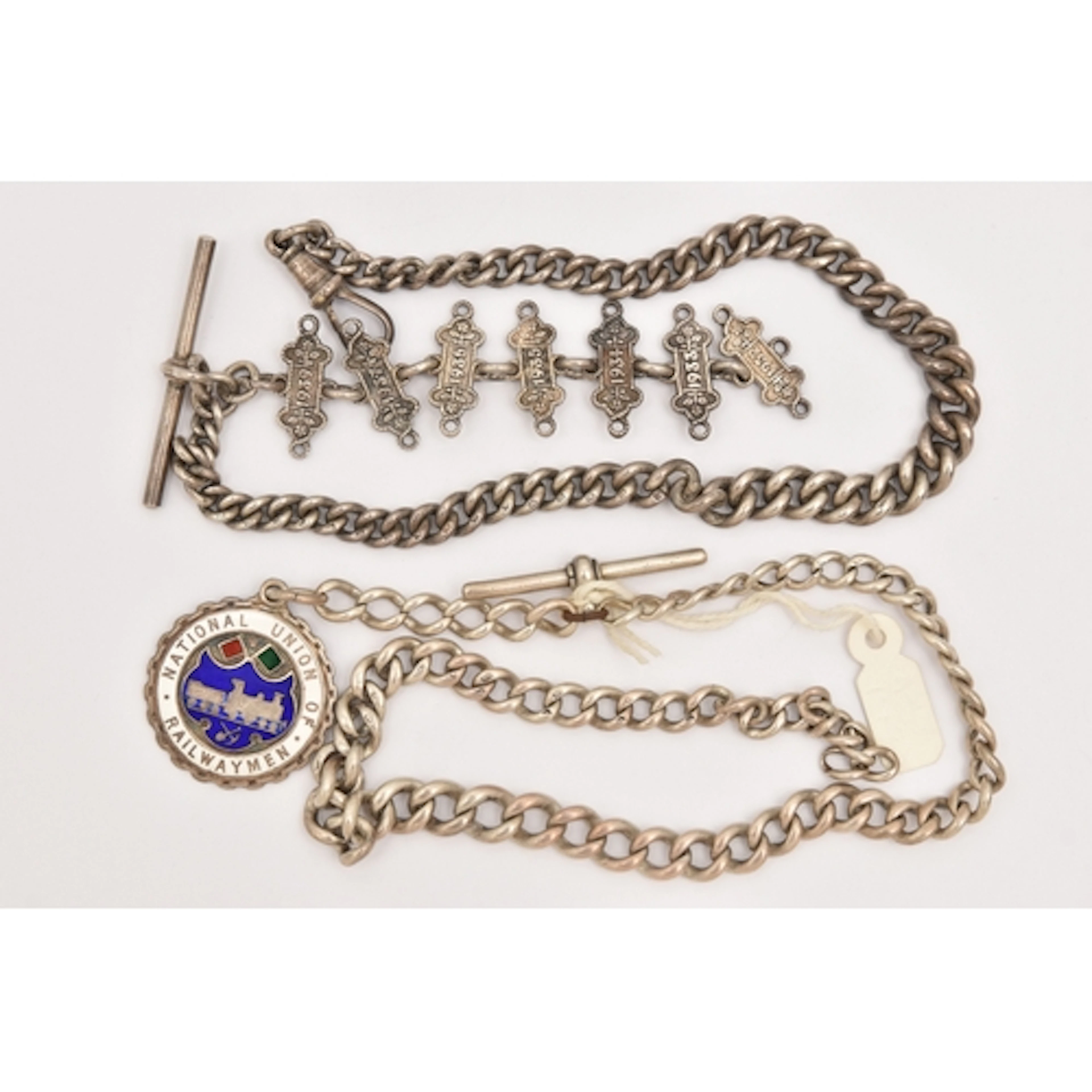 TWO SILVER ALBERT CHAINS, the first a graduated curb link ch...