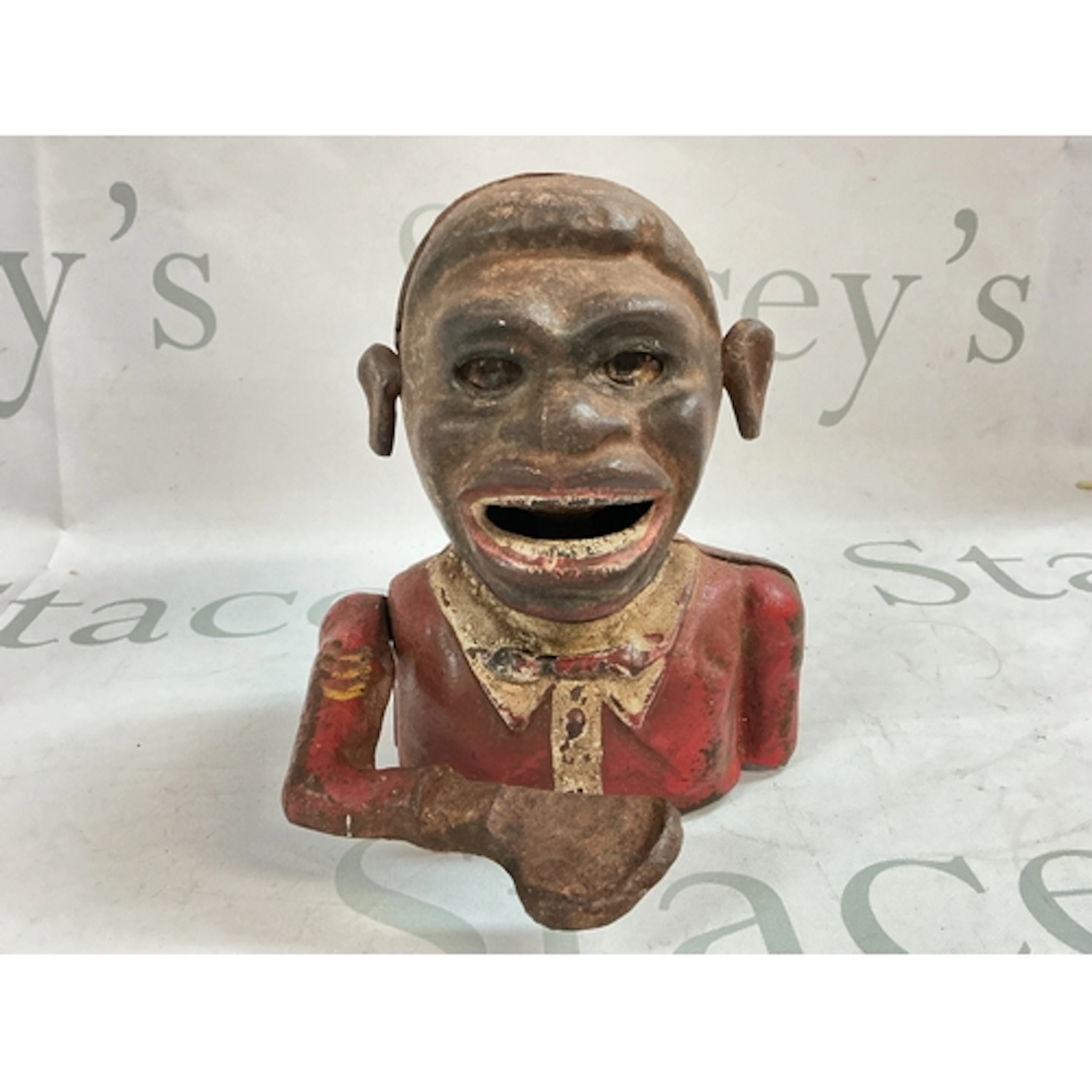 A vintage Jolly cast iron money box. 15 cm tall