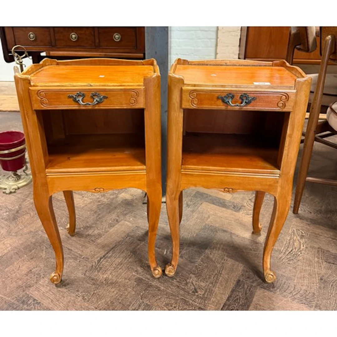 A pair of French tray topped bedside cabinets, each fitted o...