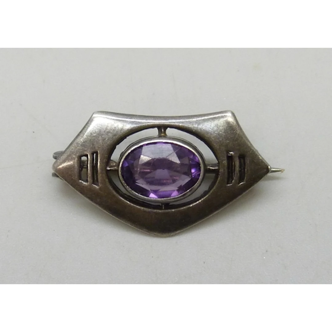 A Charles Horner Art Nouveau silver brooch set with an purpl...