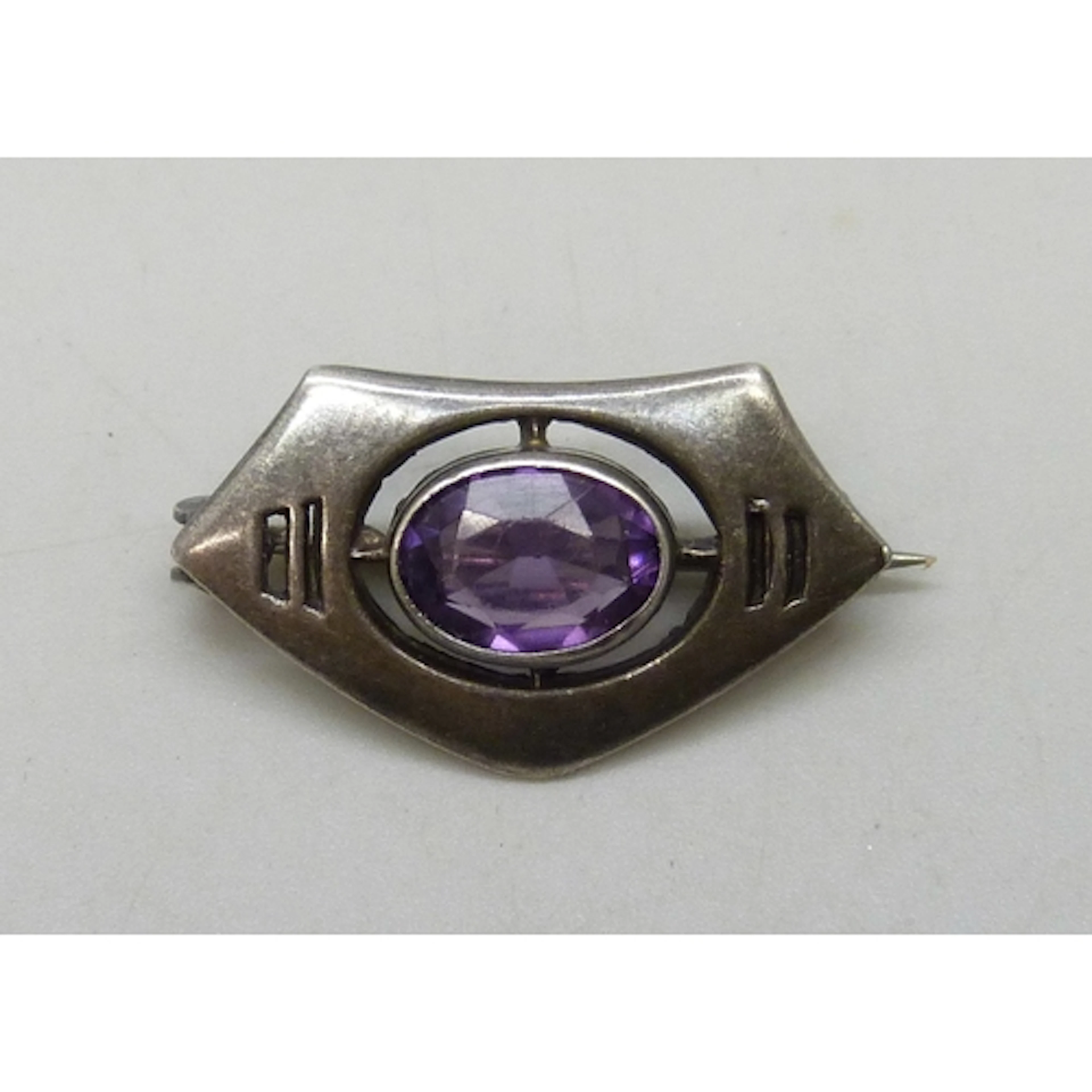 A Charles Horner Art Nouveau silver brooch set with an purpl...