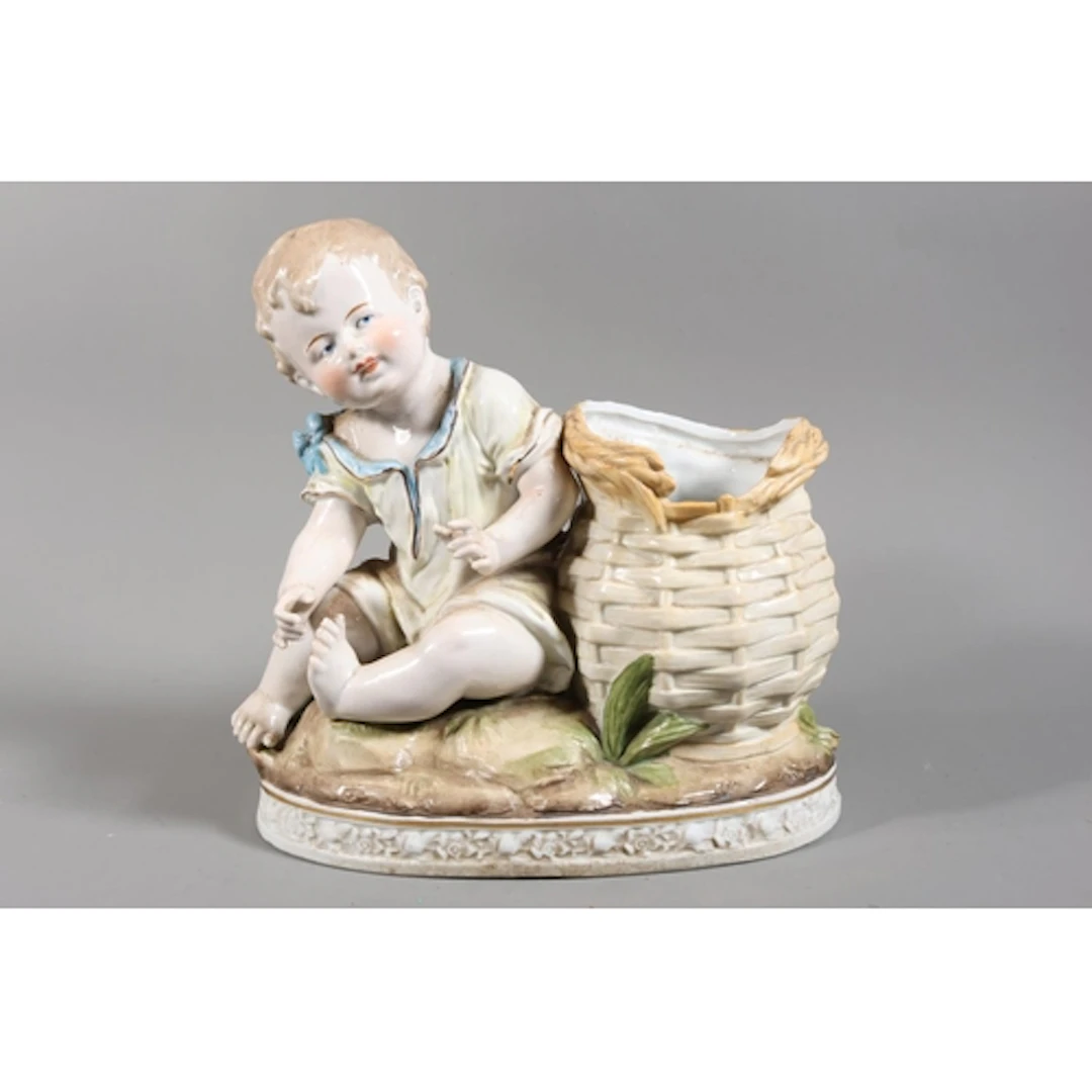 Continental flower stand modelled as a young child with bask...