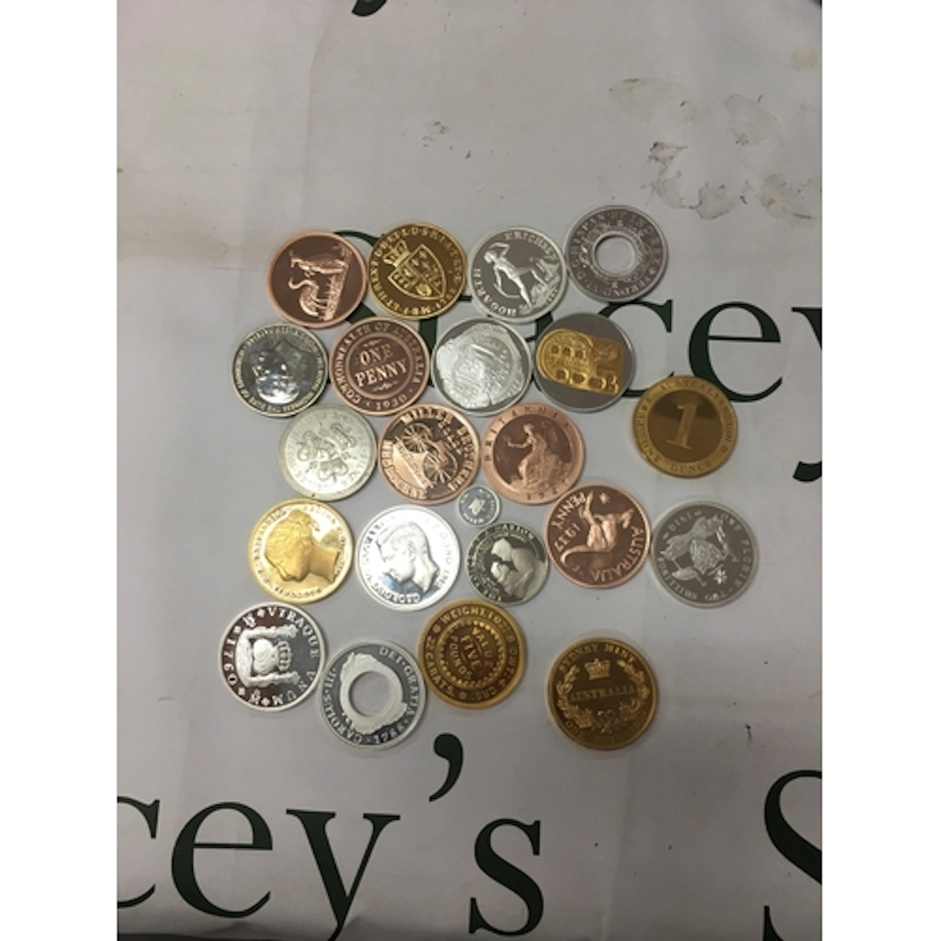 A collection of replica coins and commemorative tokens. Many...