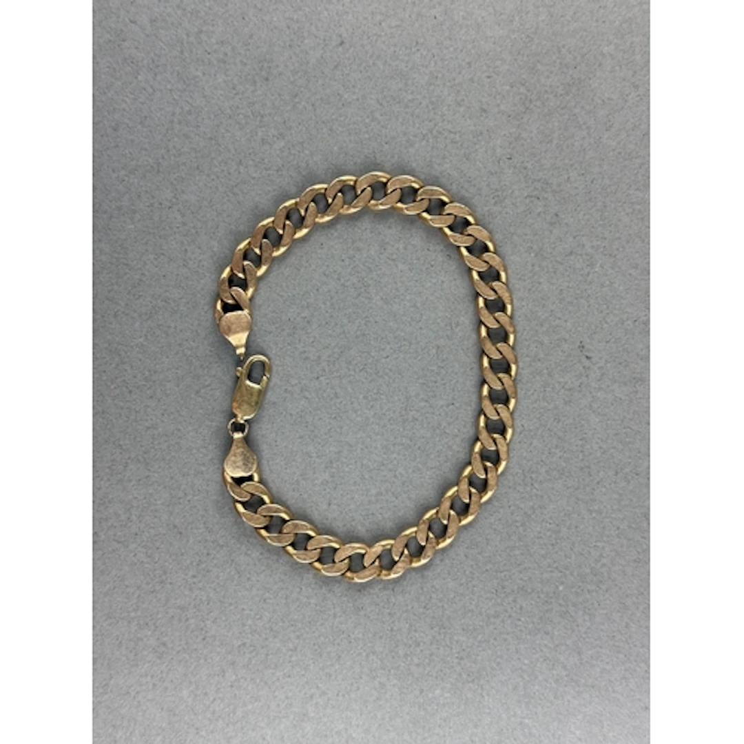Jewellery: a 9ct yellow gold curb link bracelet, 23cm, 27.0g...