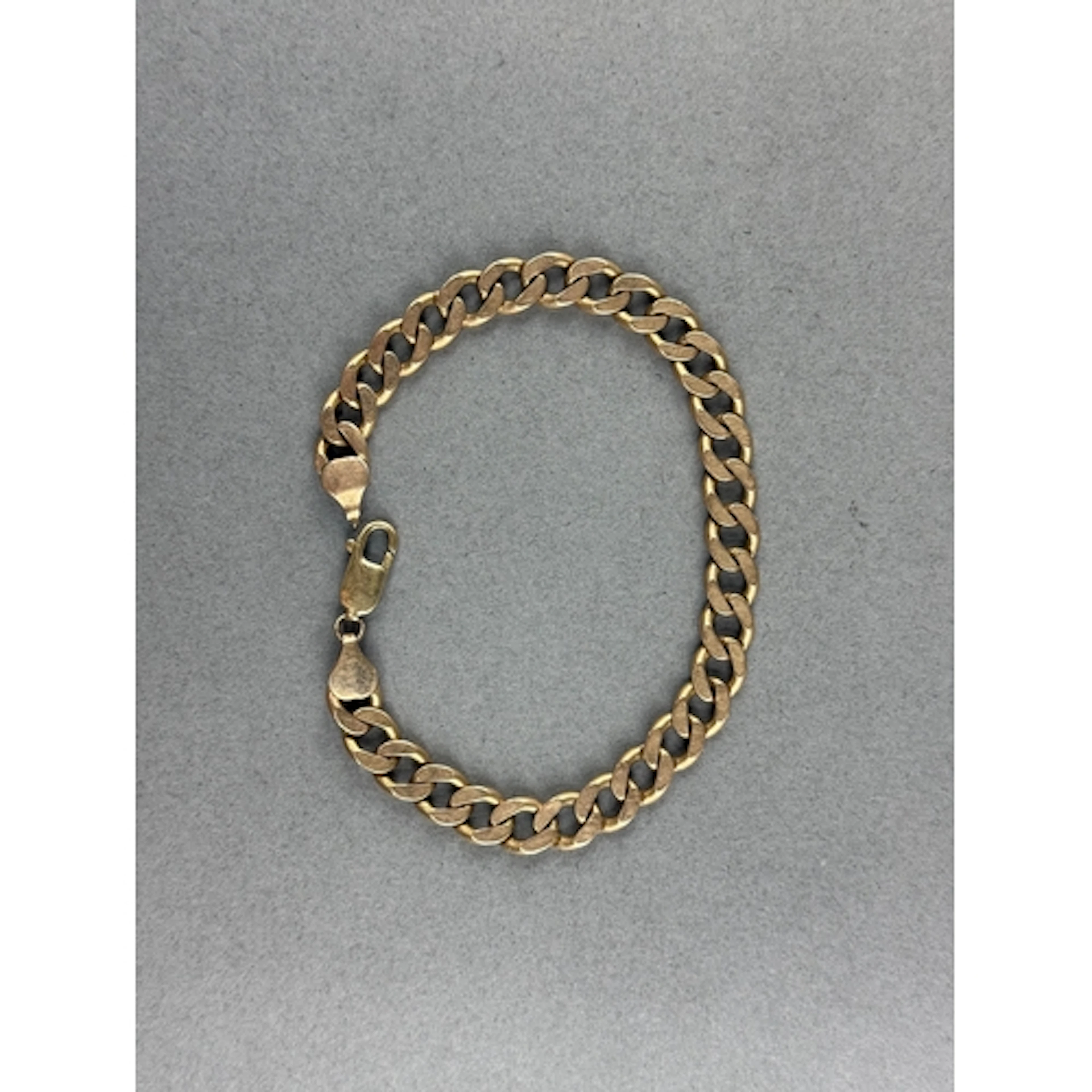Jewellery: a 9ct yellow gold curb link bracelet, 23cm, 27.0g...