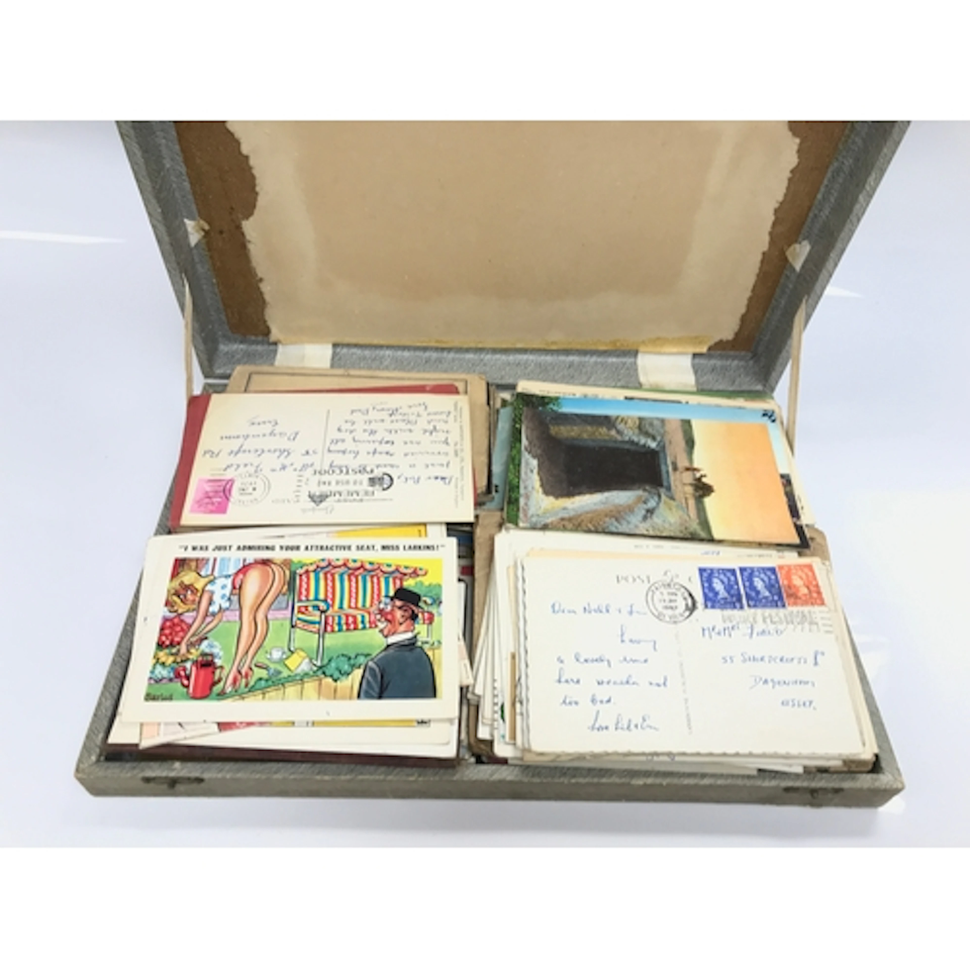 A box containing vintage postcards