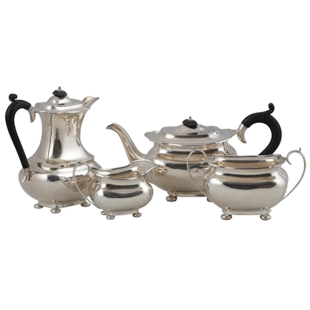 A George V matched silver four piece tea set, the teapot and...