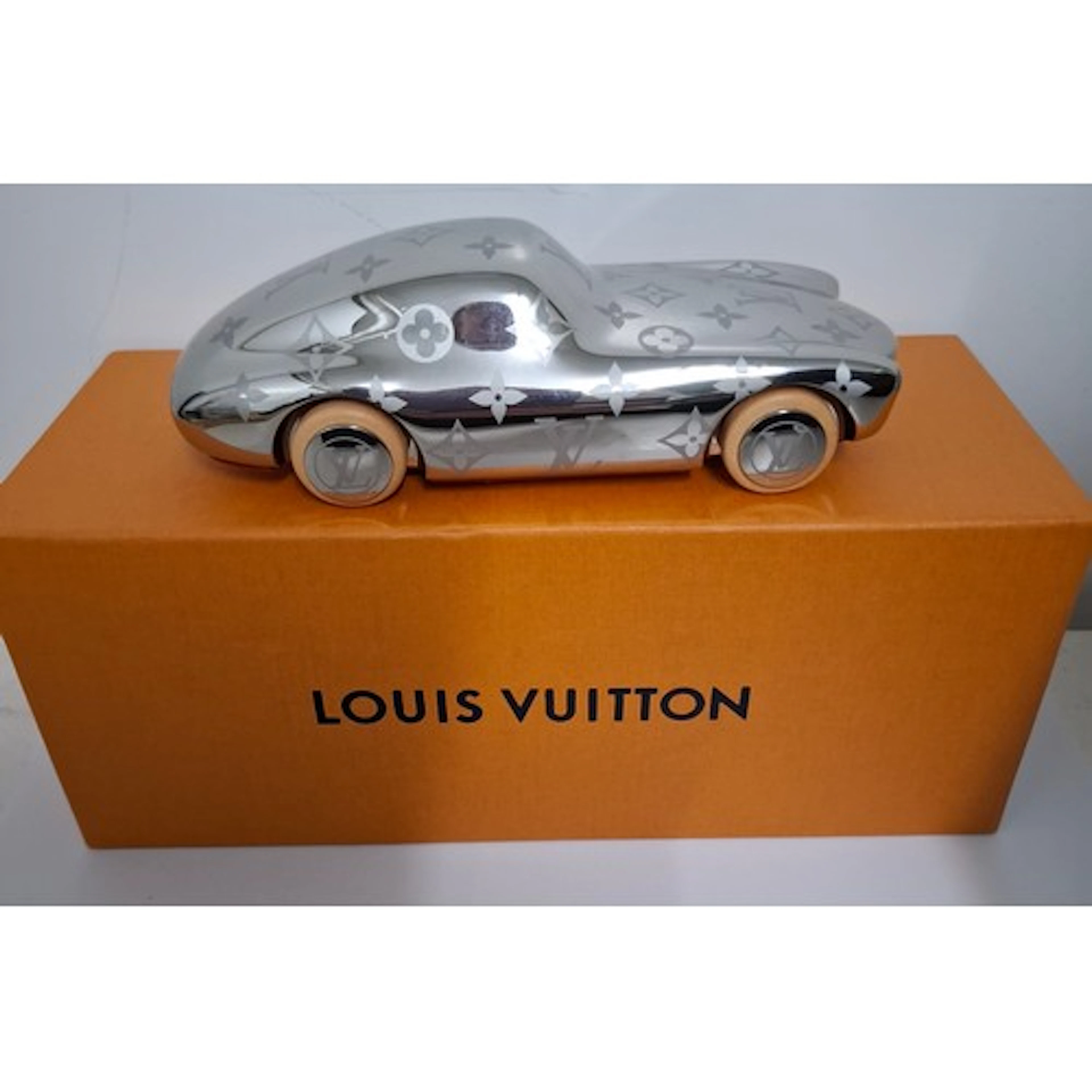 Louis Vuitton- A Voguez Volez Voyagez engraved aluminium pap...