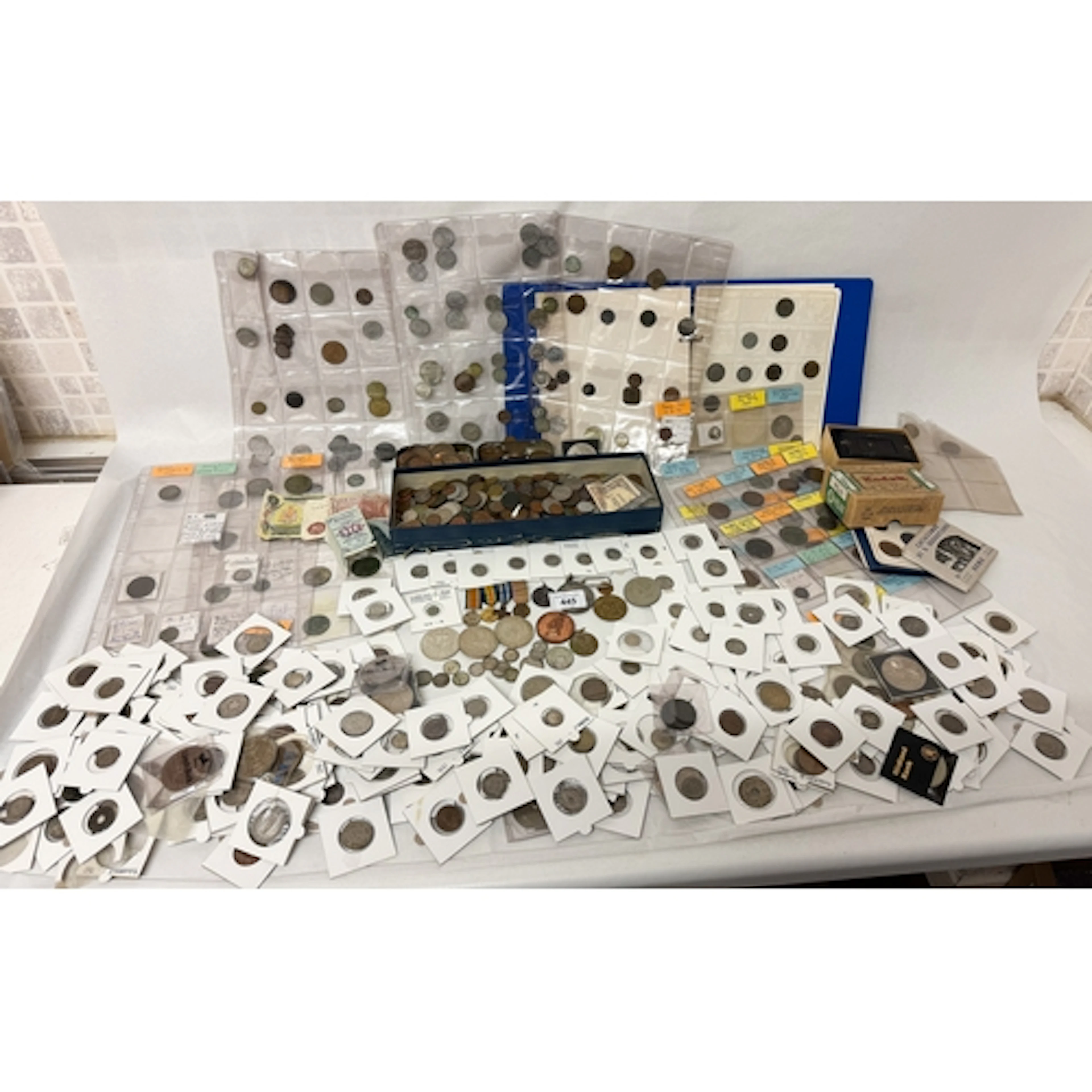 A large collection of coins contained within three albums, b...