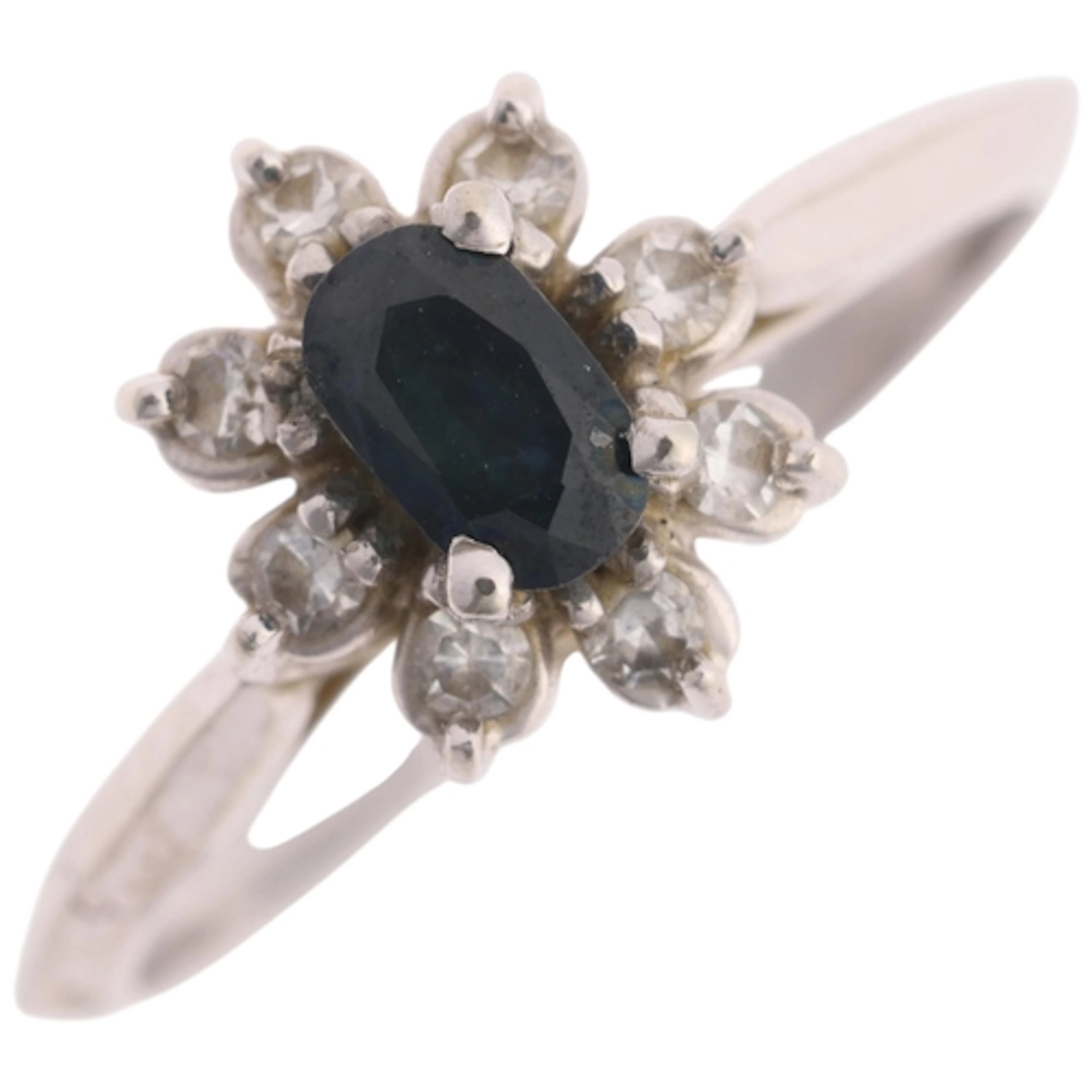 A 14ct white gold sapphire and diamond cluster ring, claw se...