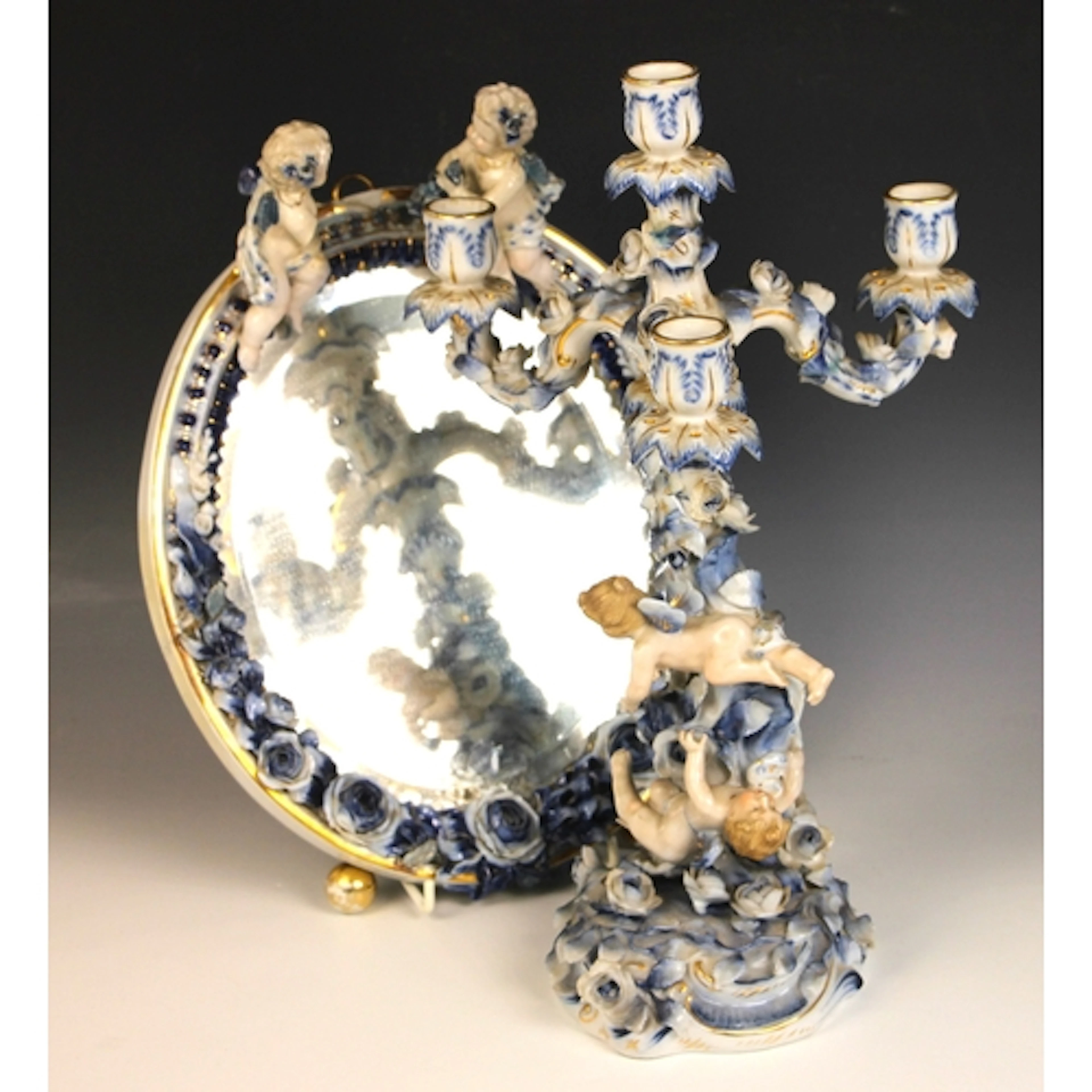 A German blue and white porcelain four branch figural candel...