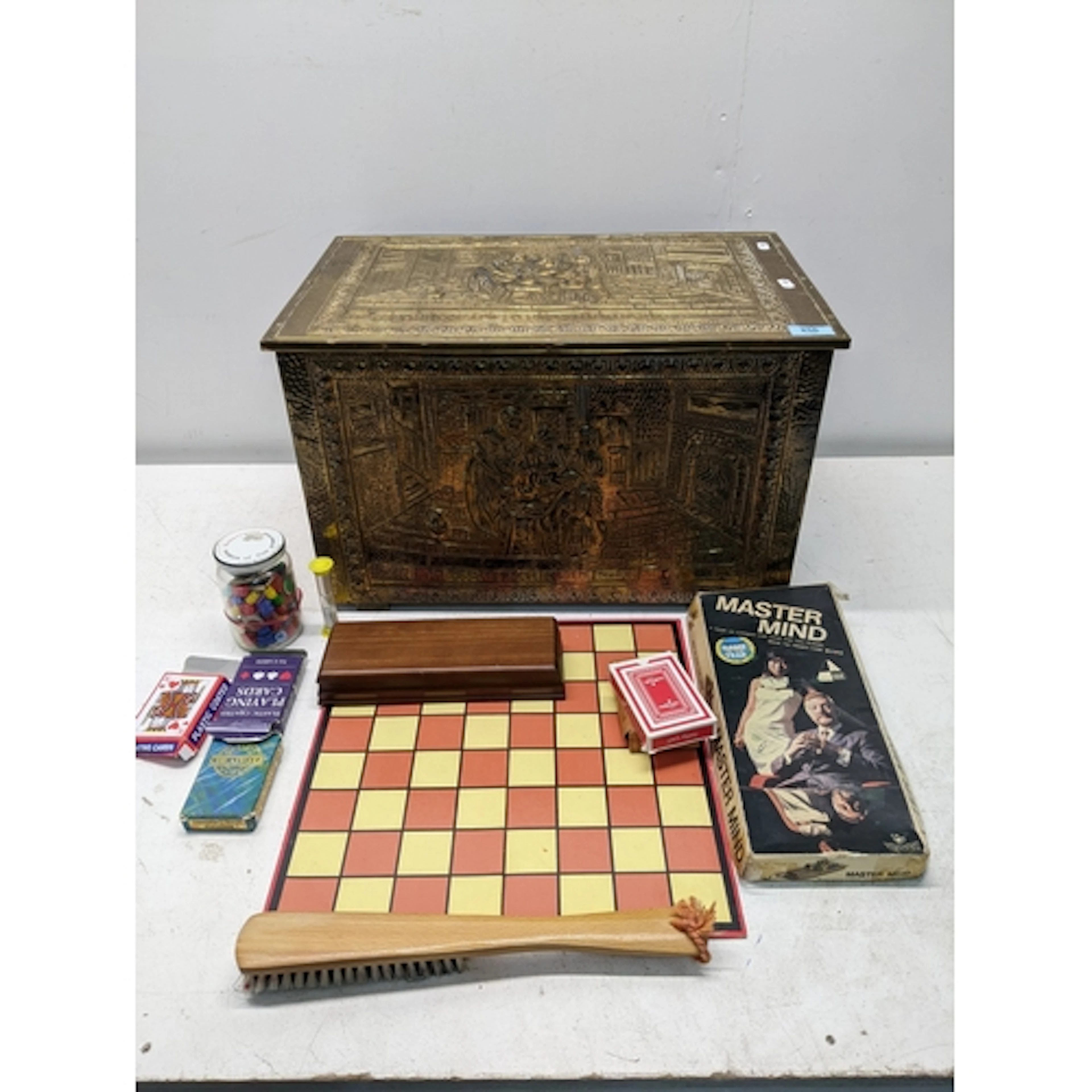A brass clad skipper box with repousse decoration, along wit...