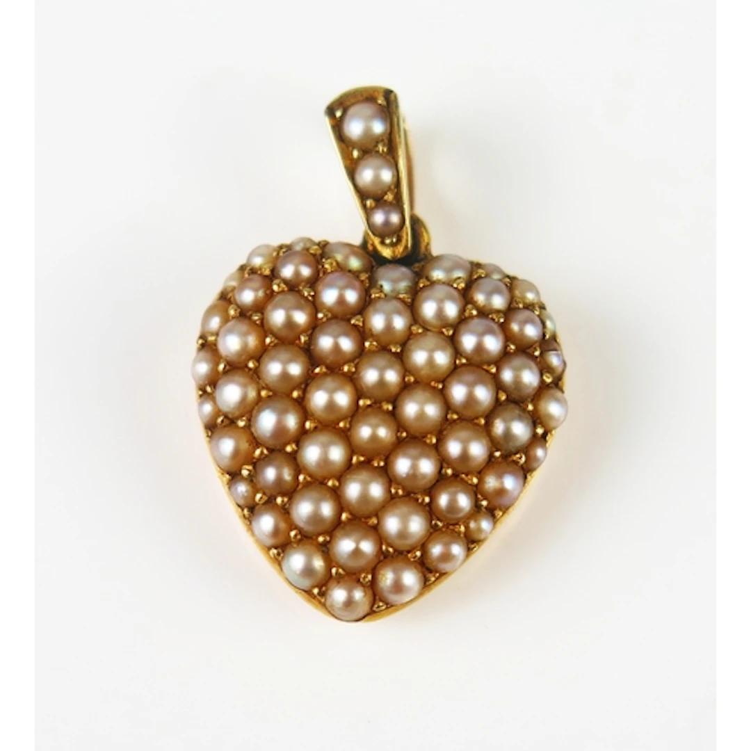 A Victorian heart shaped locket back pendant decorated with ...