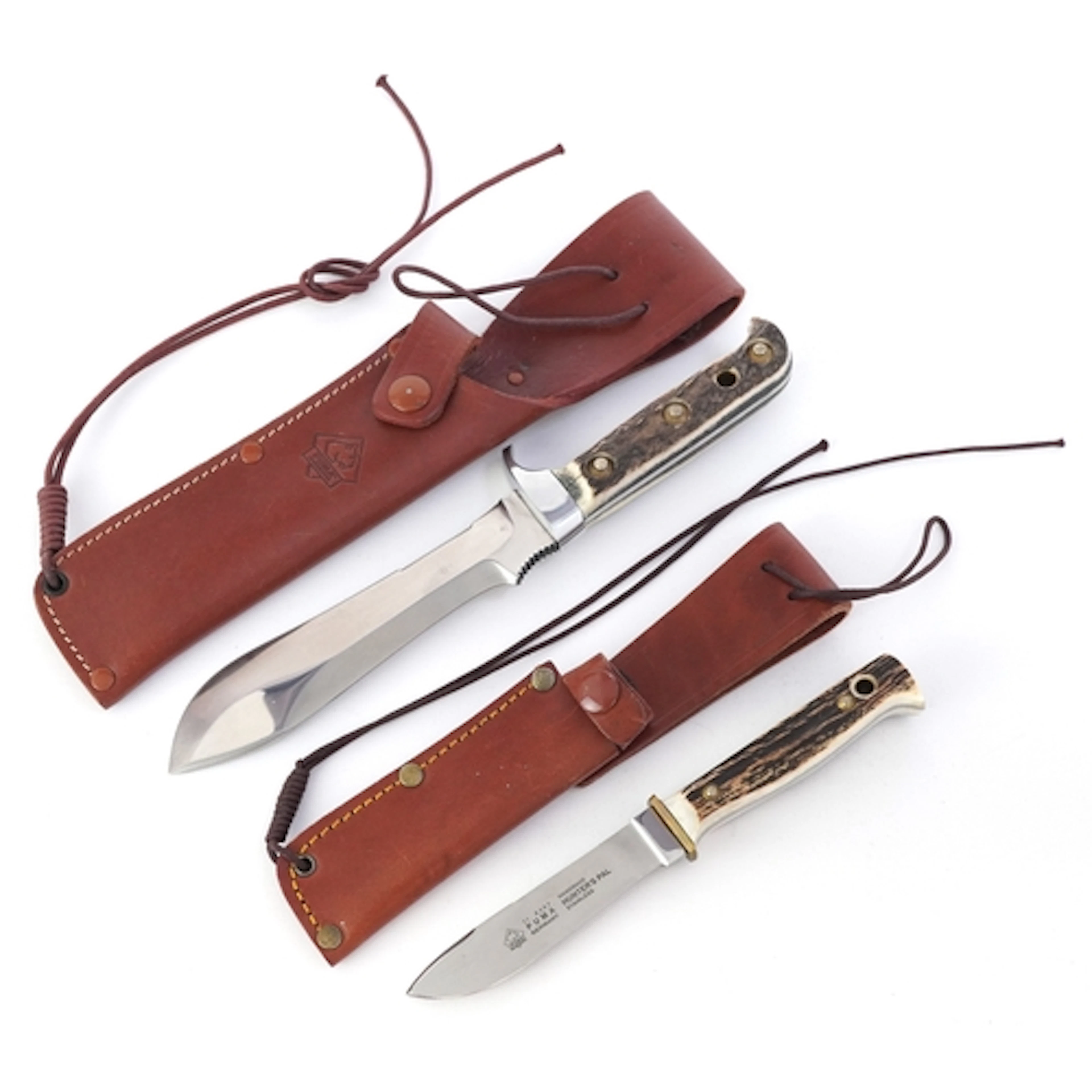 Two Puma hunting knives with staghorn handles comprising Whi...