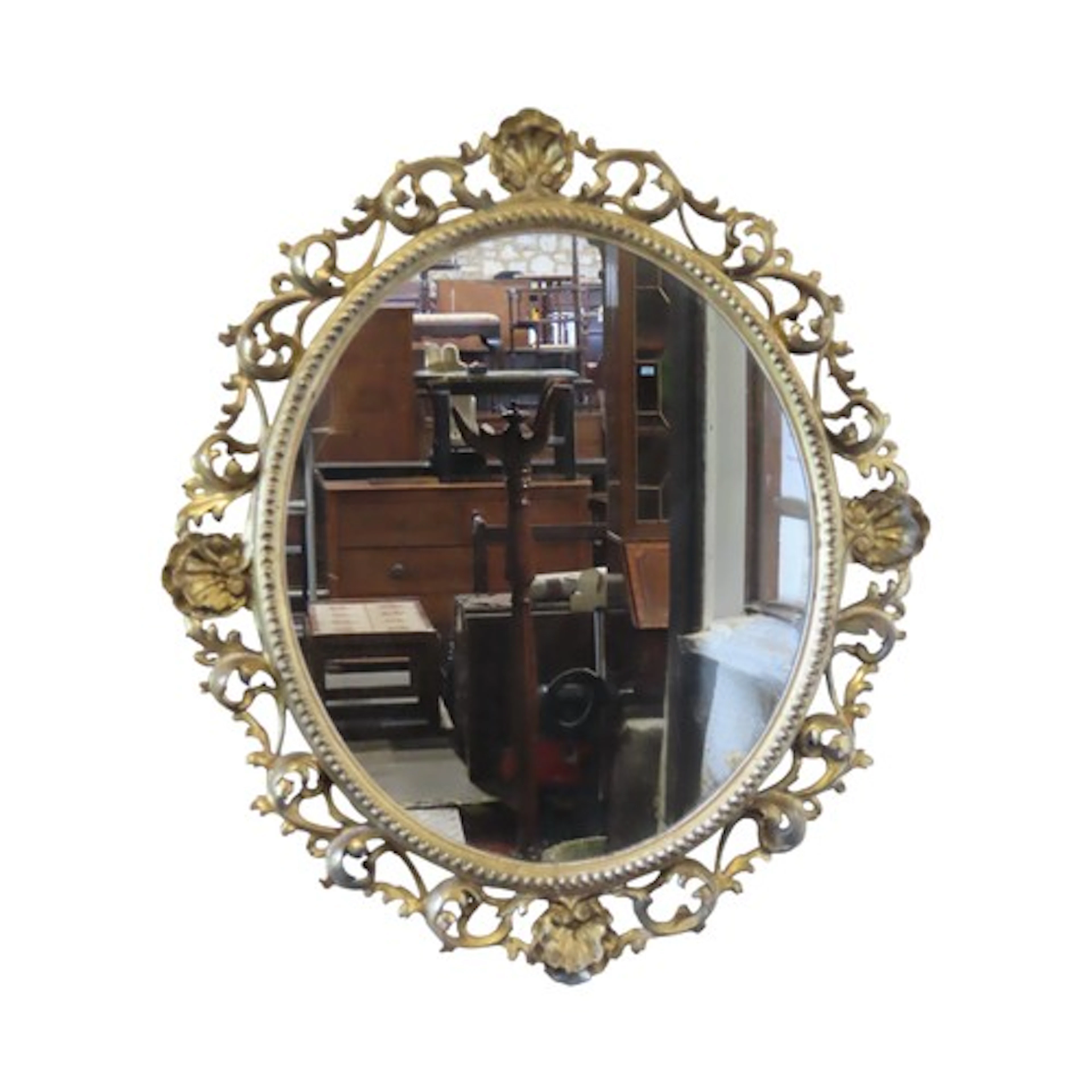 A Venetian carved gilt mirror of oval form with shell and pi...