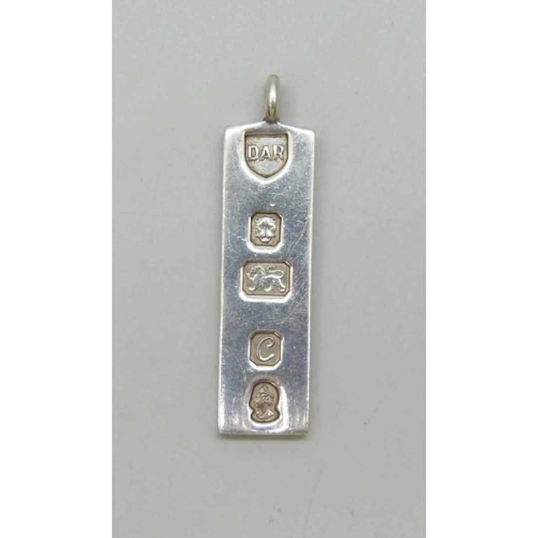 A silver ingot necklace pendant, London, 1977, 5cm including...