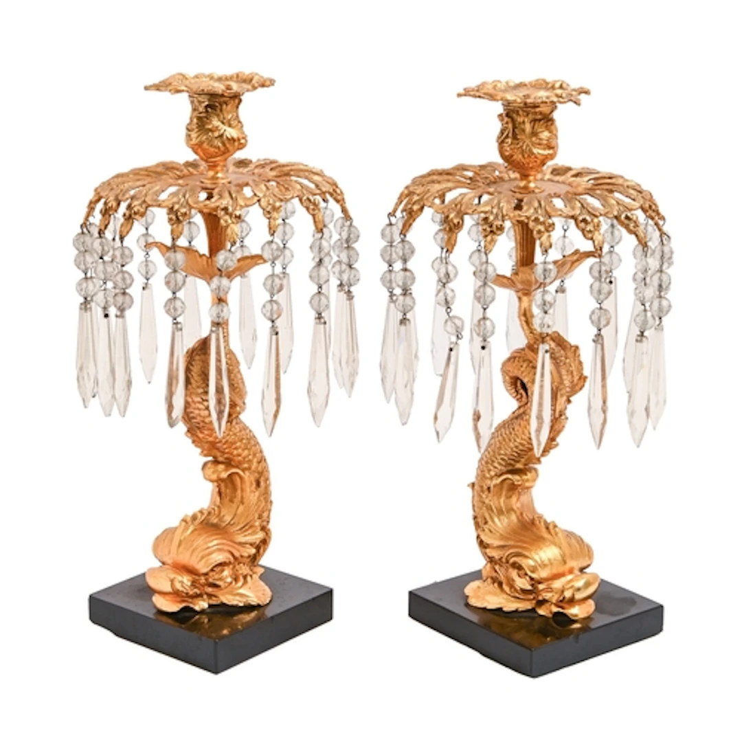 A pair of gilt bronze dolphin form lustre candlesticks, earl...